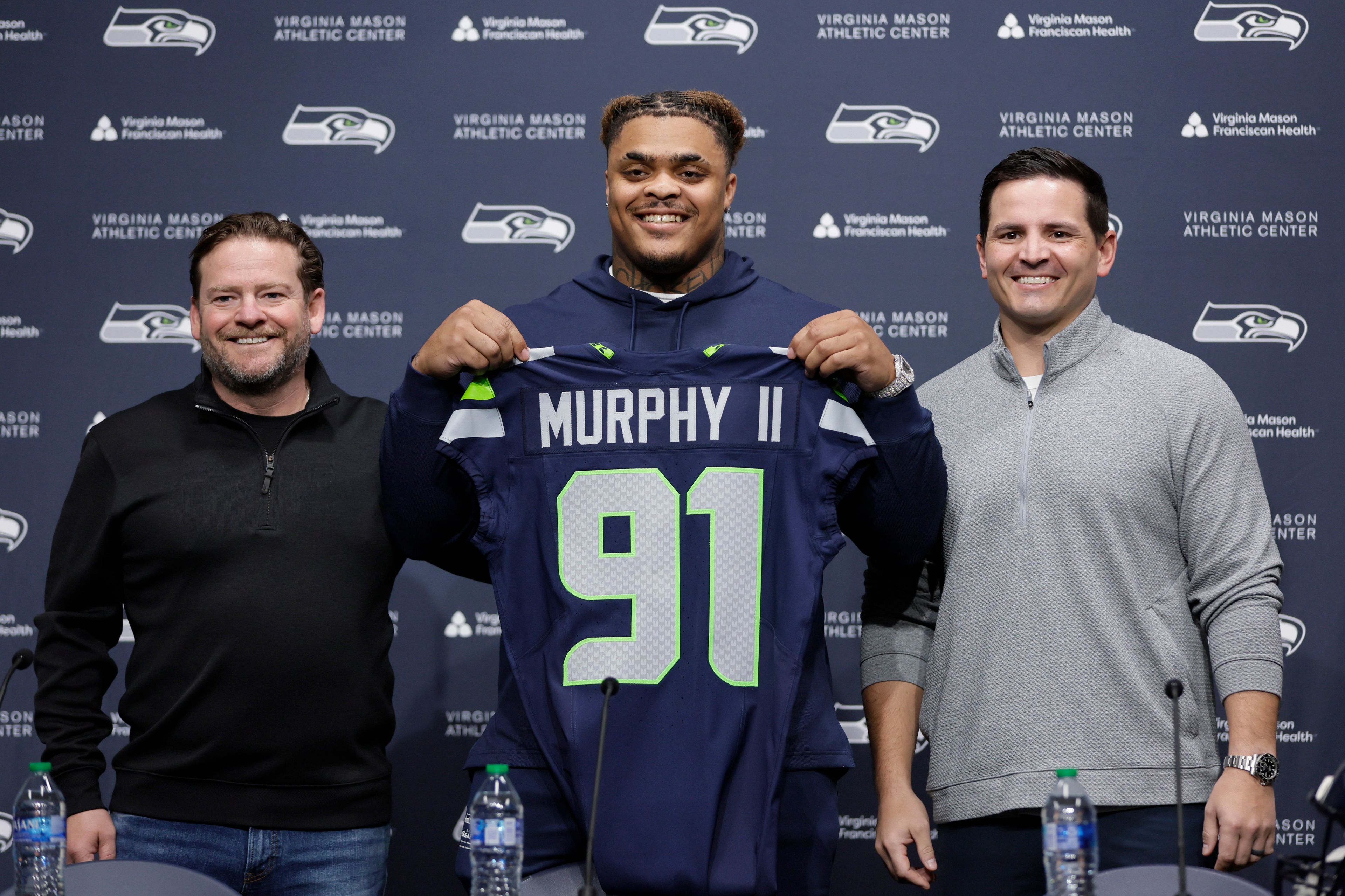 The Seahawks' 2024 first-round draft pick, Byron Murphy II, is introduced by general manager John Schneider, left, and coach Mike Macdonald, right, during a conference at the team's headquarters Thursday in Renton, Wash.