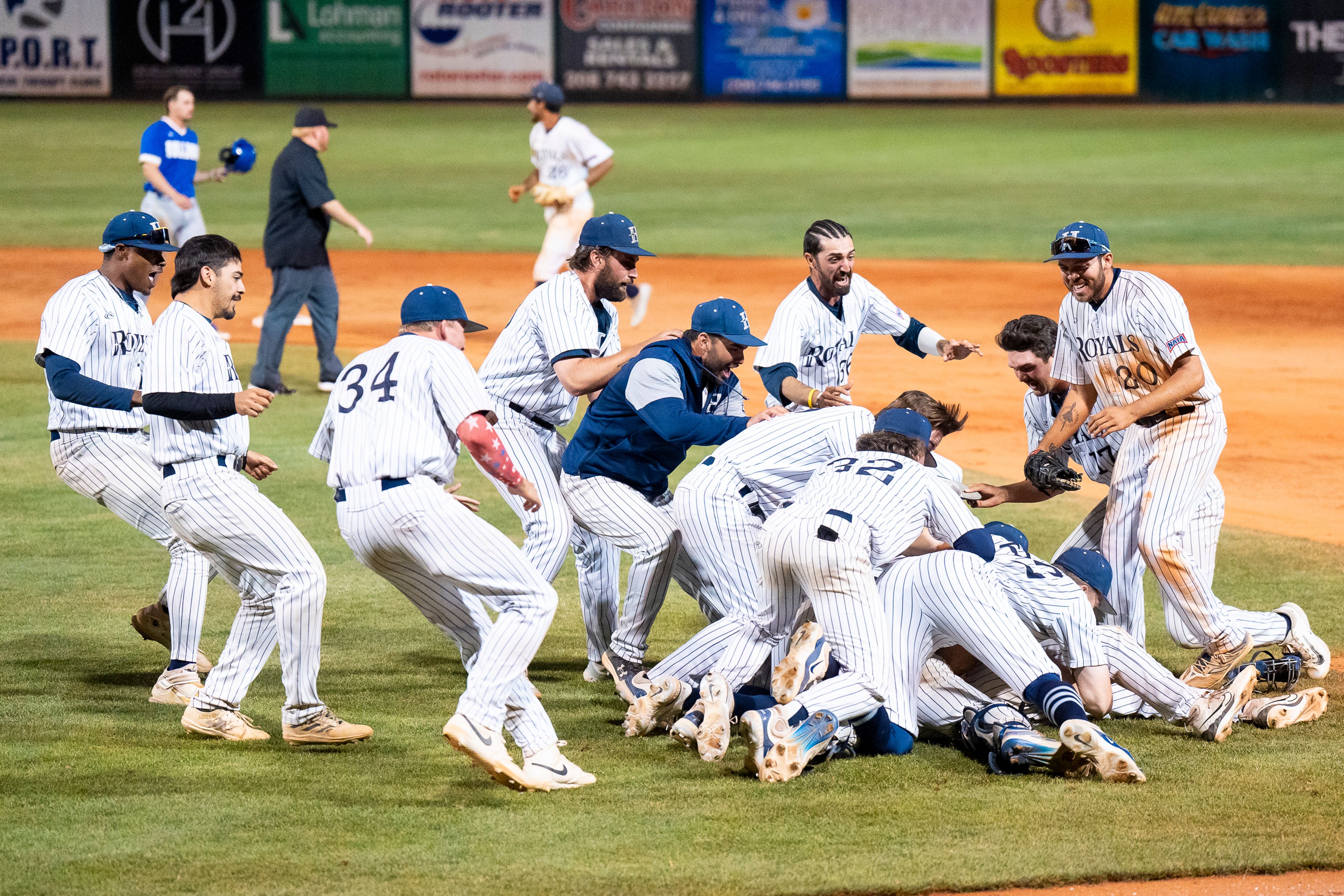 Hope International players celebrate after winning Game 19 of the NAIA World Series against Tennessee Wesleyan on Friday at Harris Field in Lewiston.