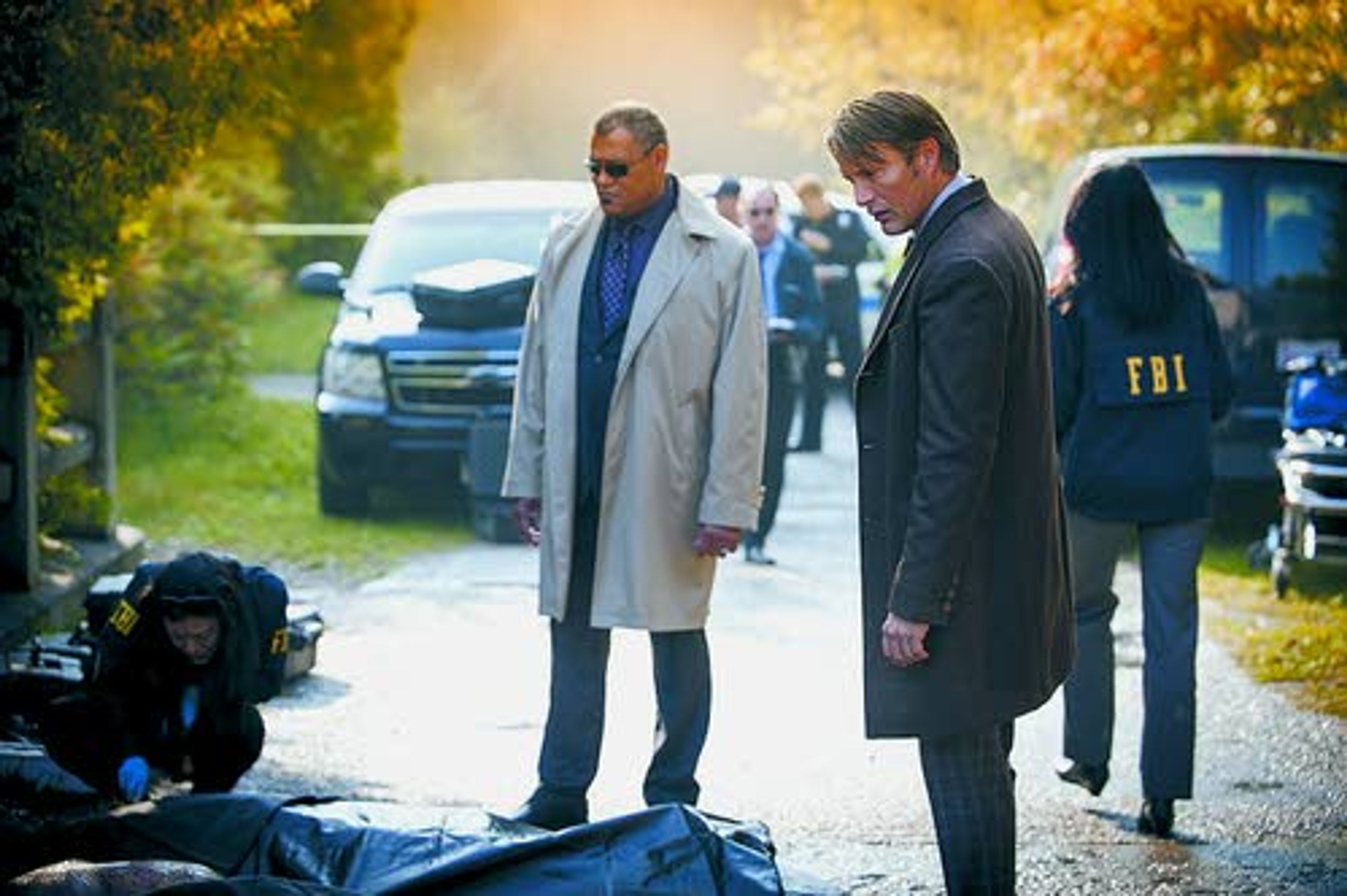 The plot thickens — In this scene from “Kaiseki,” the first episode of the second season of “Hannibal,” Mads Mikkelsen (Dr. Hannibal Lecter) and Lawrence Fishburne (FBI special agent Jack Crawford) inspect a crime scene.