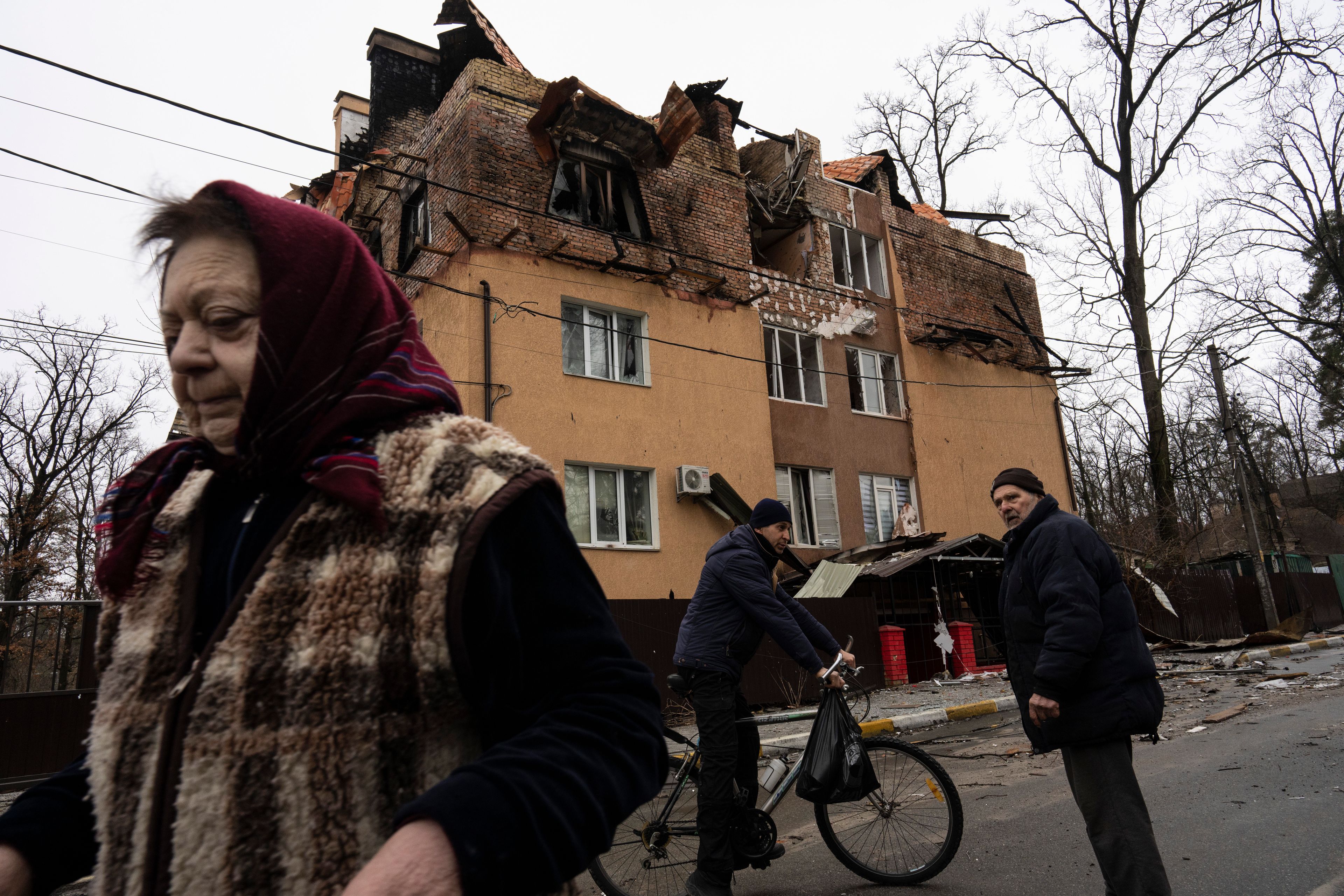 People walk and talk to each other in Irpin, on the outskirts of Kyiv, Ukraine, Saturday, April 2, 2022. As Russian forces pull back from Ukraine’s capital region, retreating troops are creating a “catastrophic" situation for civilians by leaving mines around homes, abandoned equipment and “even the bodies of those killed," President Volodymyr Zelenskyy warned Saturday. (AP Photo/Rodrigo Abd)