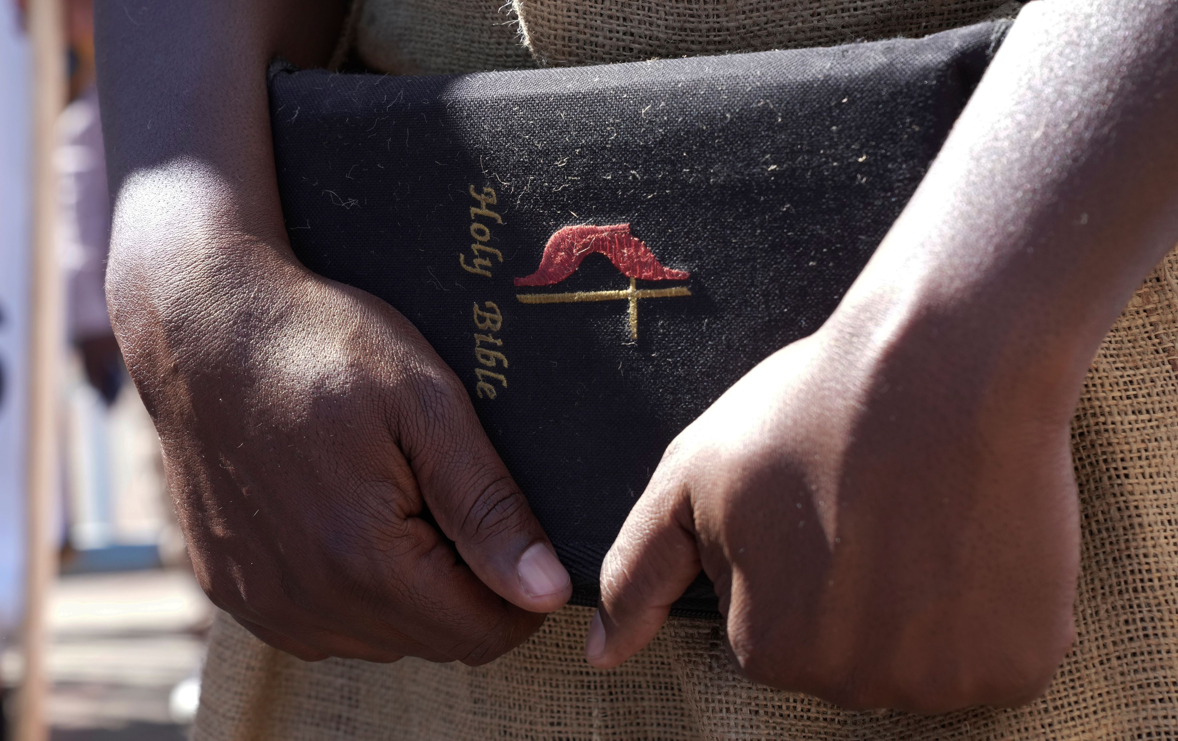 A member the United Methodist Church in Zimbabwe holds a bible while protesting at the church premises in Harare, Thursday, May 30, 2024. The protests denouncing homosexuality and the departure of the church from the scriptures and doctrine, come barely a month after the United Methodist Church Worldwide General Conference held in North Carolina, US repealed their church's longstanding ban on LGBTQ clergy, removing a rule forbidding "self-avowed practising homosexuals" from being ordained or appointed as ministers.