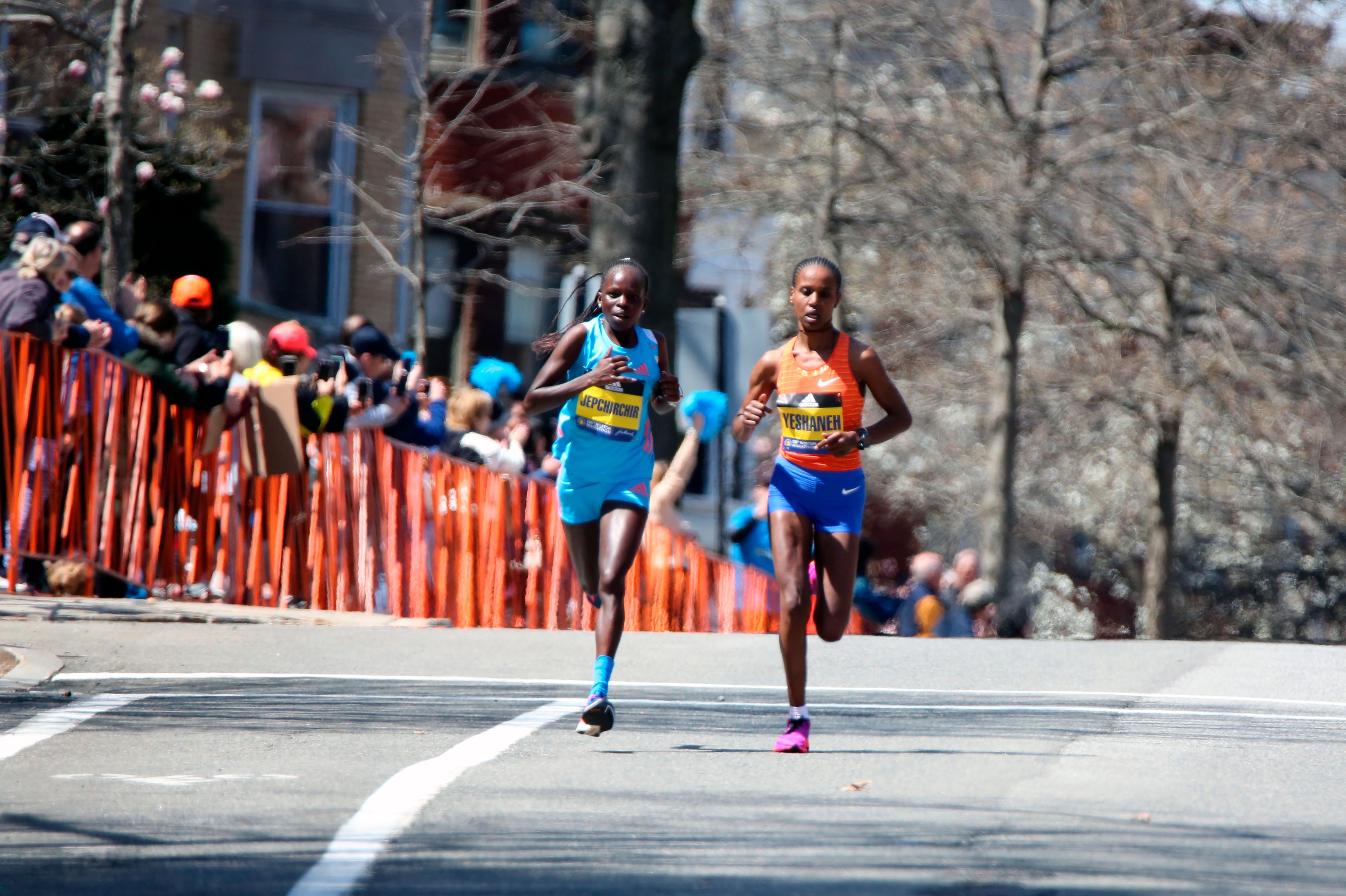 Peres Jepchirchir, of Kenya, left, and Ababel Yeshaneh, of Ethiopia, compete in the 126th Boston Marathon in Brookline, Mass., Monday, April 18, 2022. Jepchirchir won the race and Yeshaneh finished second. (AP Photo/Jennifer McDermott)