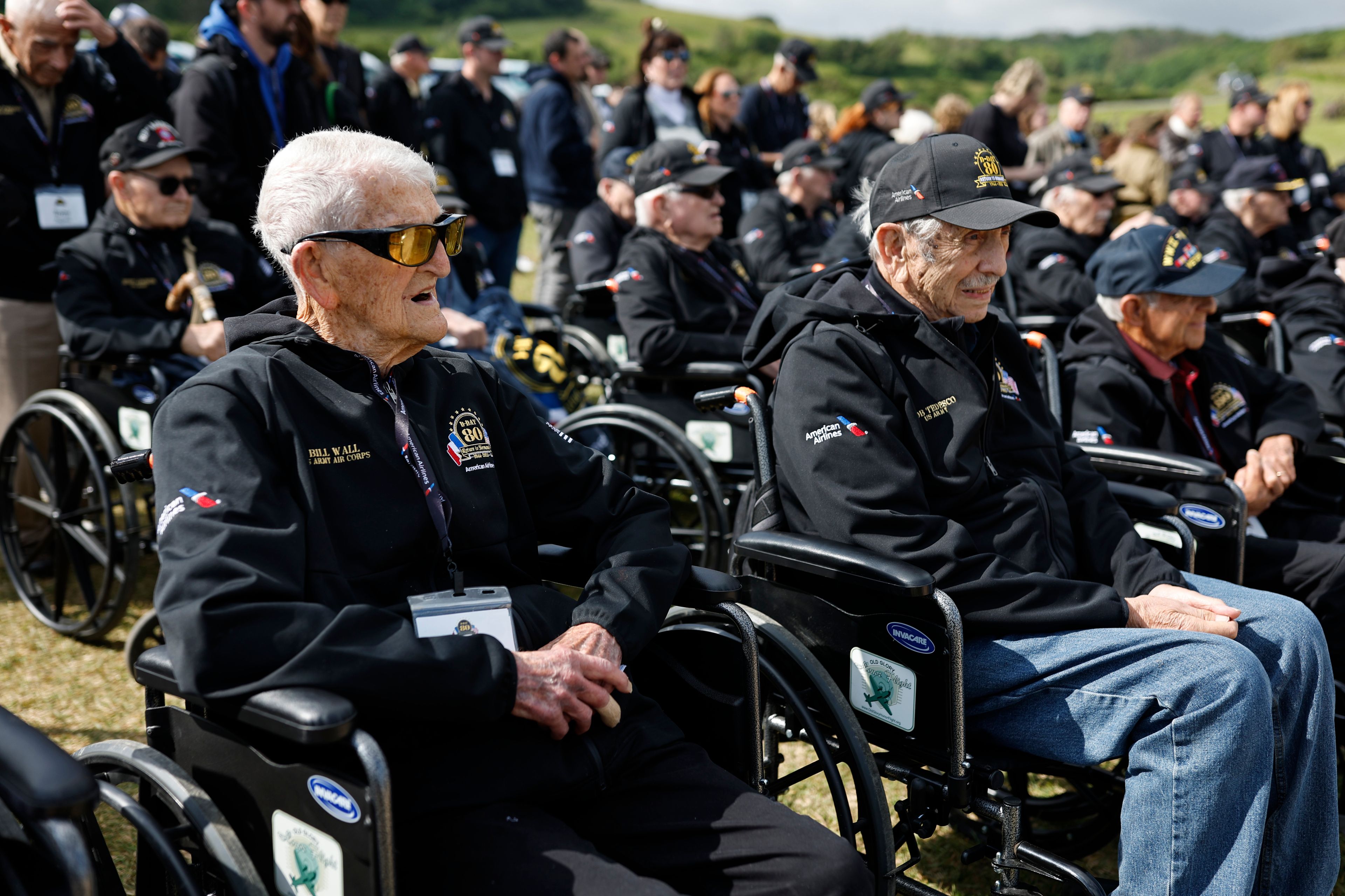 American WWII veterans Bill Wall, left, and Bob Tedesco attend a ceremony on Omaha Beach, Tuesday, June 4, 2024 in Normandy. World War II veterans from across the United States as well as Britain and Canada are in Normandy this week to mark 80 years since the D-Day landings that helped lead to Hitler's defeat. (AP Photo/Jeremias Gonzalez)