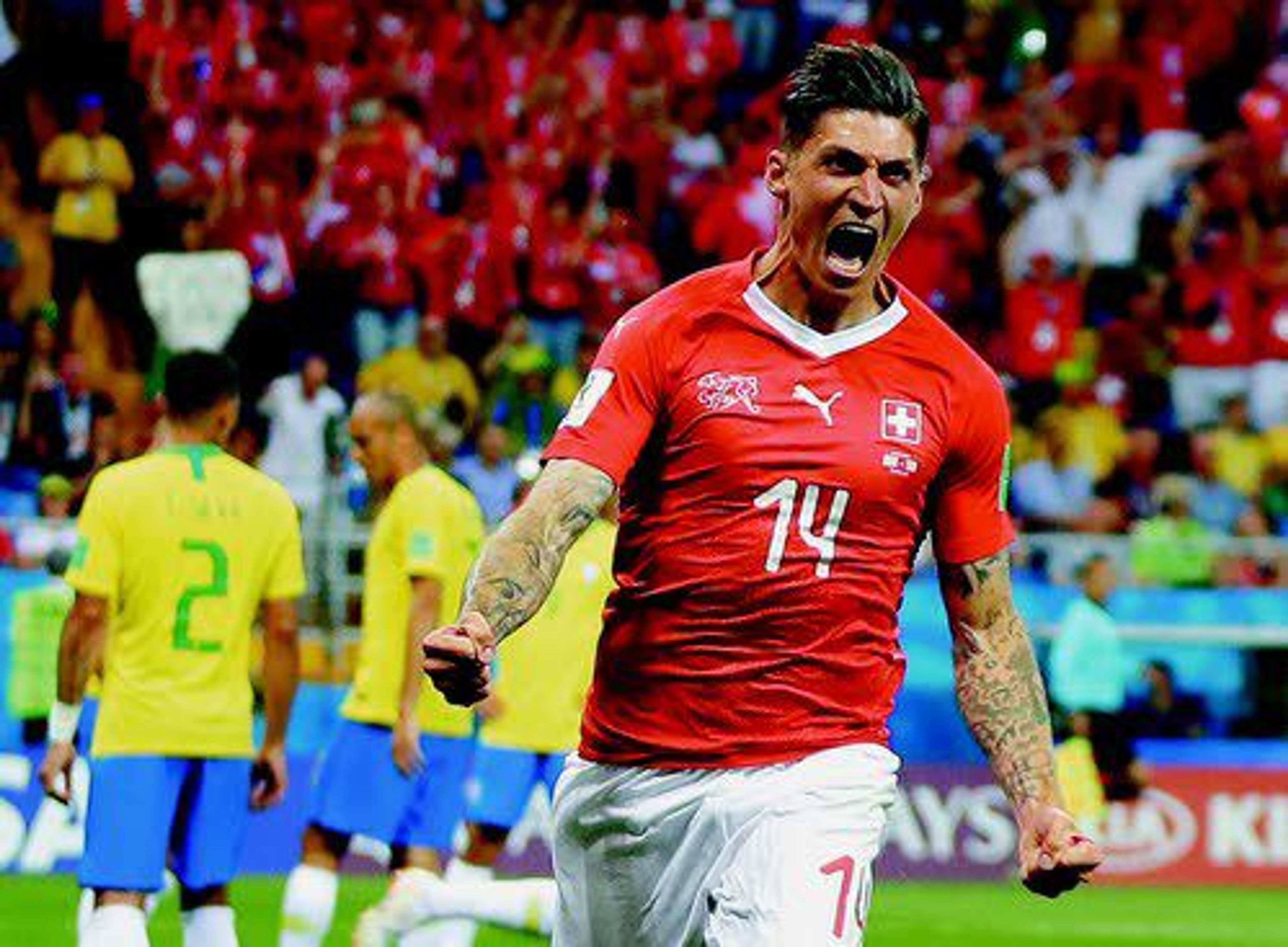 Switzerland’s Steven Zuber celebrates after scoring his side’s opening goal during a match against Brazil. The teams tied 1-1 on Sunday.