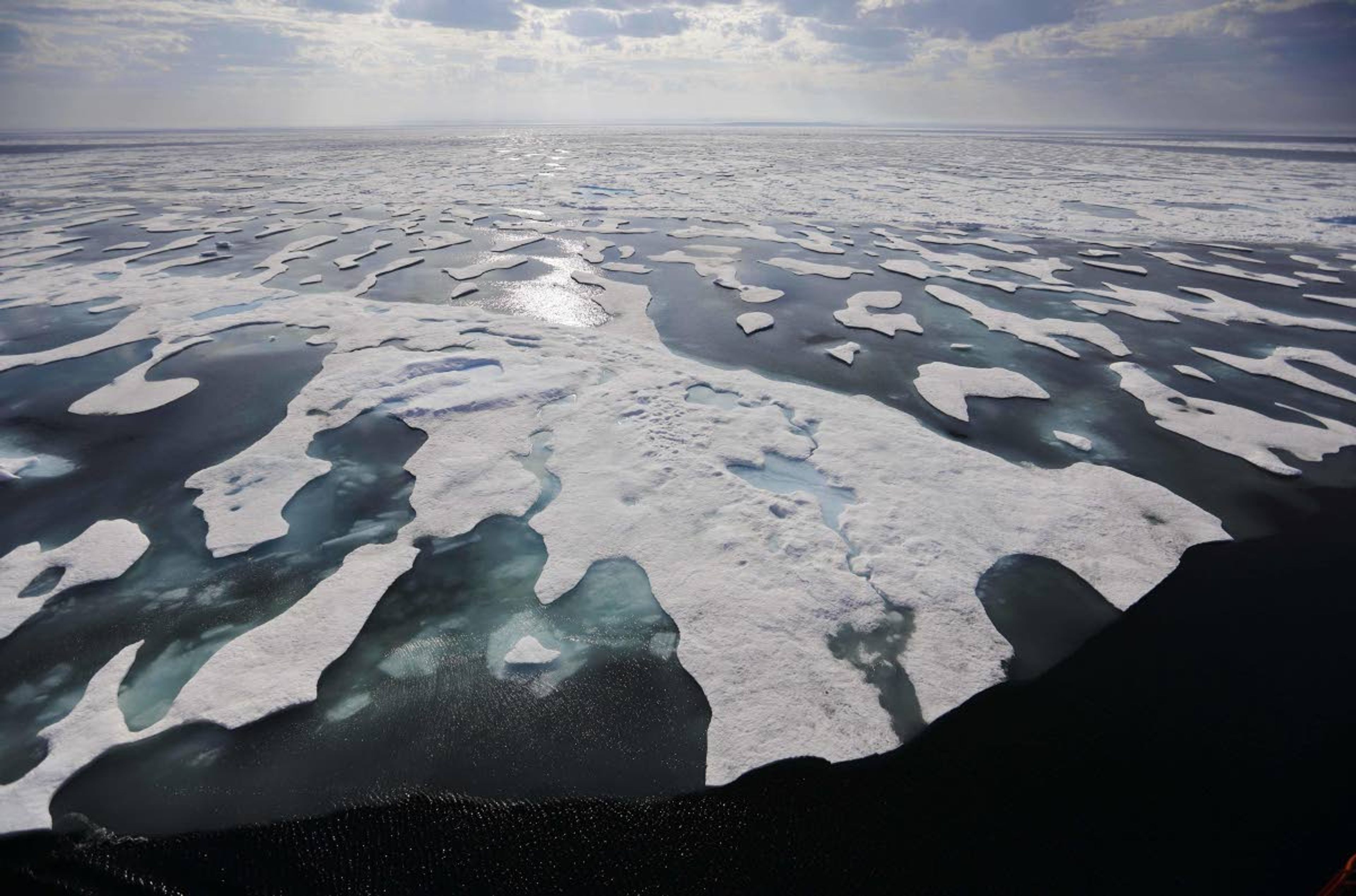 Sea ice melts in July 2017 on the Franklin Strait along the Northwest Passage in the Canadian Arctic Archipelago. Because of climate change, more sea ice is being lost each summer than is being replenished in winters. Less sea ice coverage also means that less sunlight will be reflected off the surface of the ocean in a process known as the albedo effect. The oceans will absorb more heat, further fueling global warming.