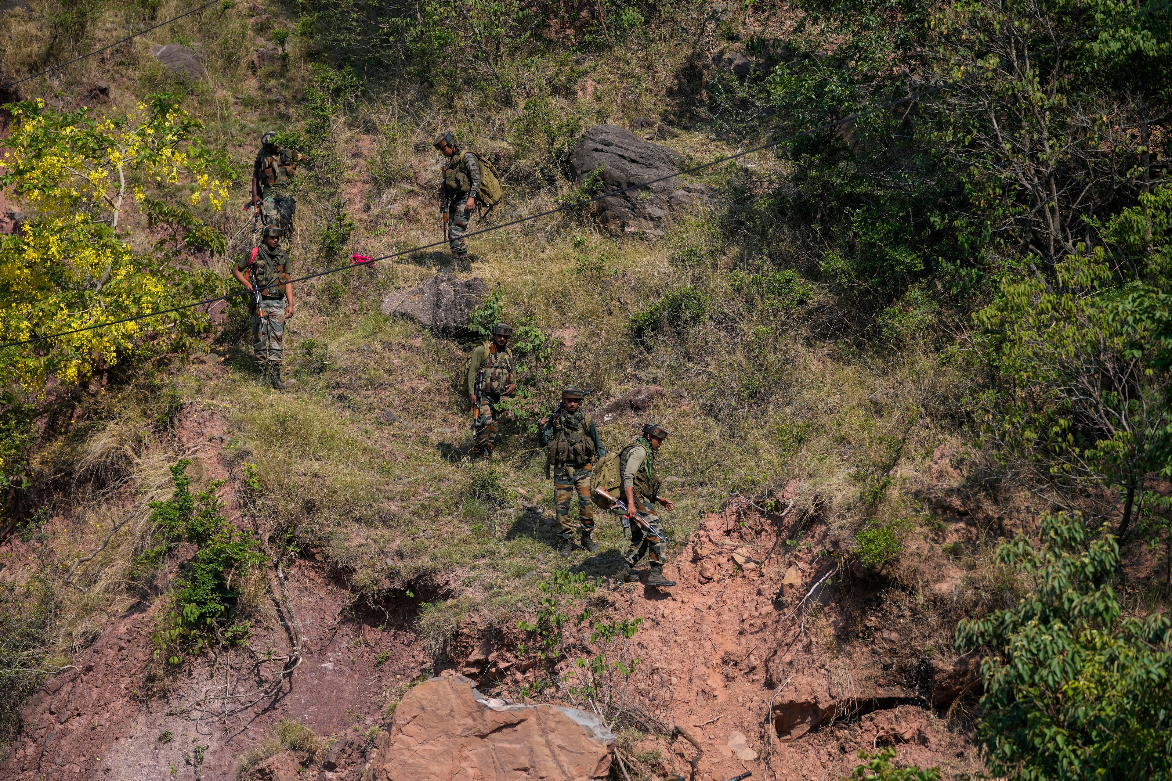 Indian army soldiers patrol the area where a bus fell into a deep gorge on Sunday after being fired at by suspected militants in Reasi district, Jammu and Kashmir, Monday, June 10, 2024. The bus was carrying pilgrims to the base camp of the famed Hindu temple Mata Vaishno Devi when it came under attack killing at least nine people.