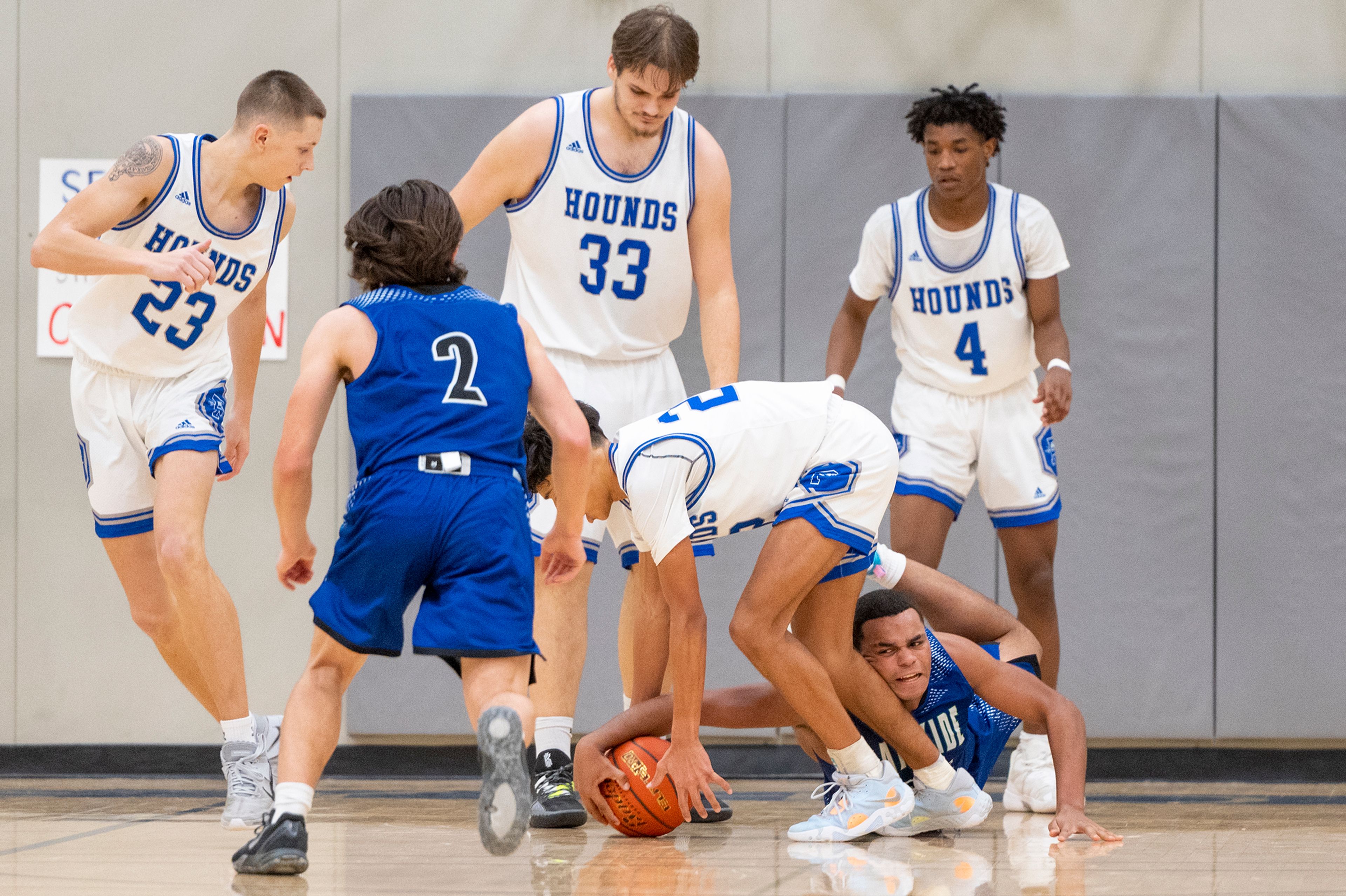 Pullman guard Caleb Northcroft, center right, fights for a loose ball with Lakeside forward Zeshawn Griffin during Friday's nonleague game.