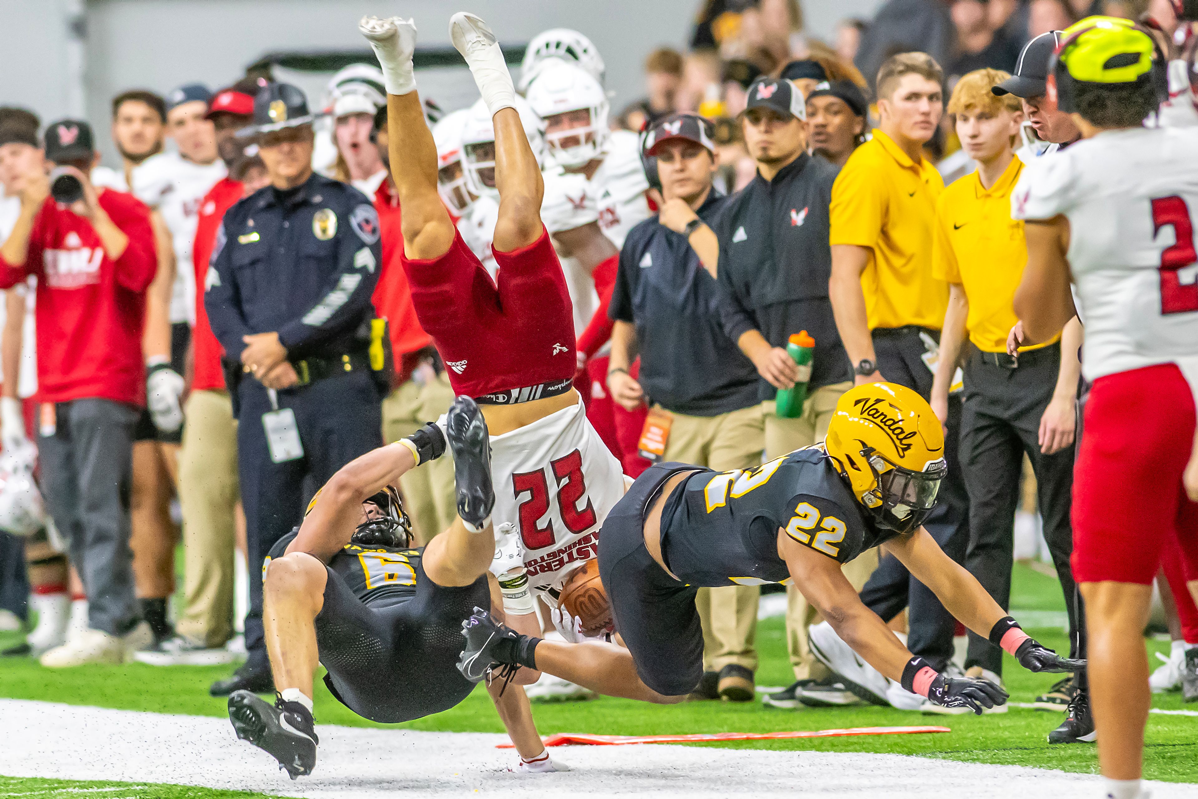 Eastern Washington wide receiver Noah Cronquist is flipped upside down after a tackle by Idaho defensive back Dwayne McDougle (22) and Idaho linebacker Jaxton Eck during a Big Sky game Saturday at the Kibbie Dome in Moscow. ,