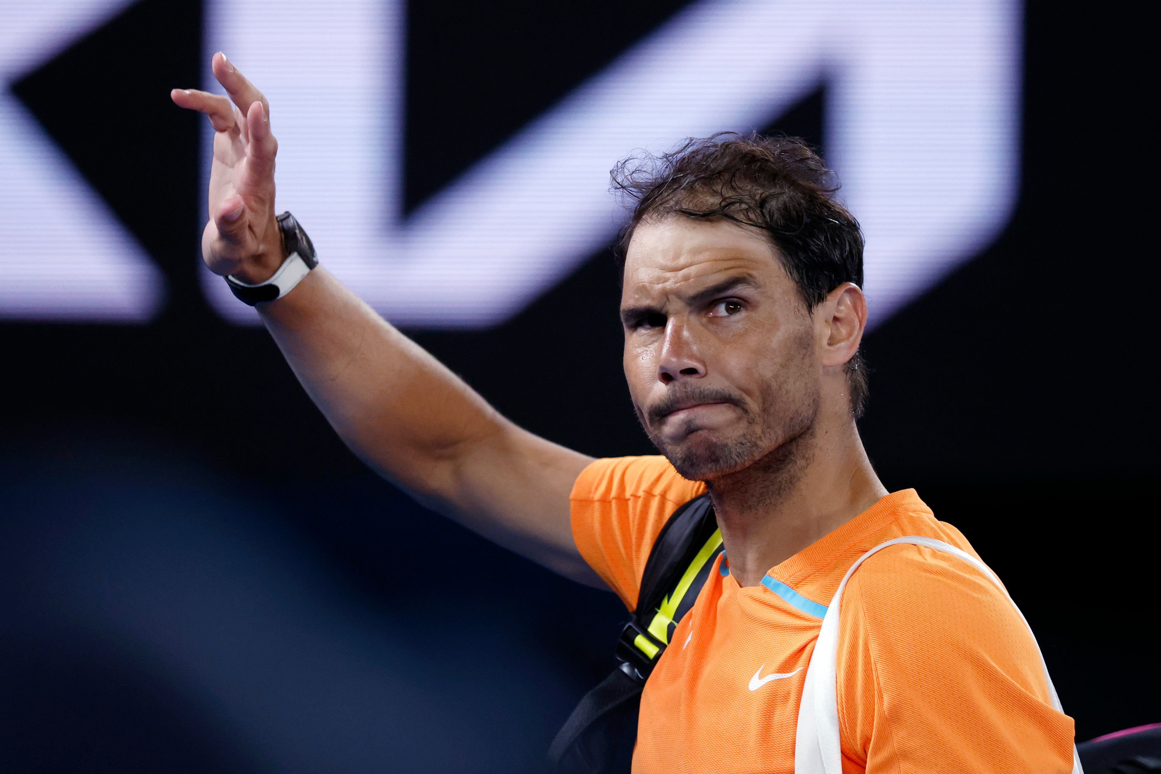 Rafael Nadal of Spain waves as he leaves Rod Laver Arena following his second round loss to Mackenzie McDonald of the U.S. at the Australian Open tennis championship in Melbourne, Australia, Wednesday, Jan. 18, 2023. (AP Photo/Asanka Brendon Ratnayake)