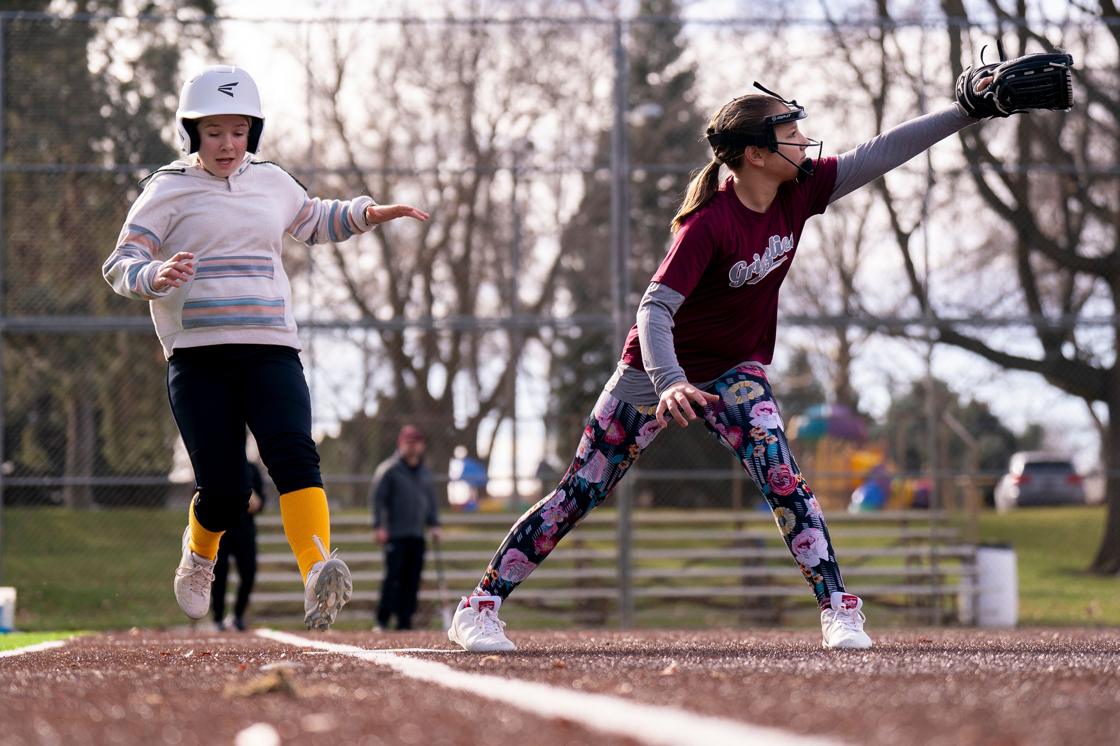 Alyssa Rader, right, 11, catches the ball as Lyla Thompson, 11, runs to first base in a fielding drill during the Cutthroats’ softball team practice on Saturday at P1FCU Field next to Hereth Park in the Lewiston Orchards. The team is apart of Hells Canyon Sports and includes an under 10 and under 12 year-old teams.