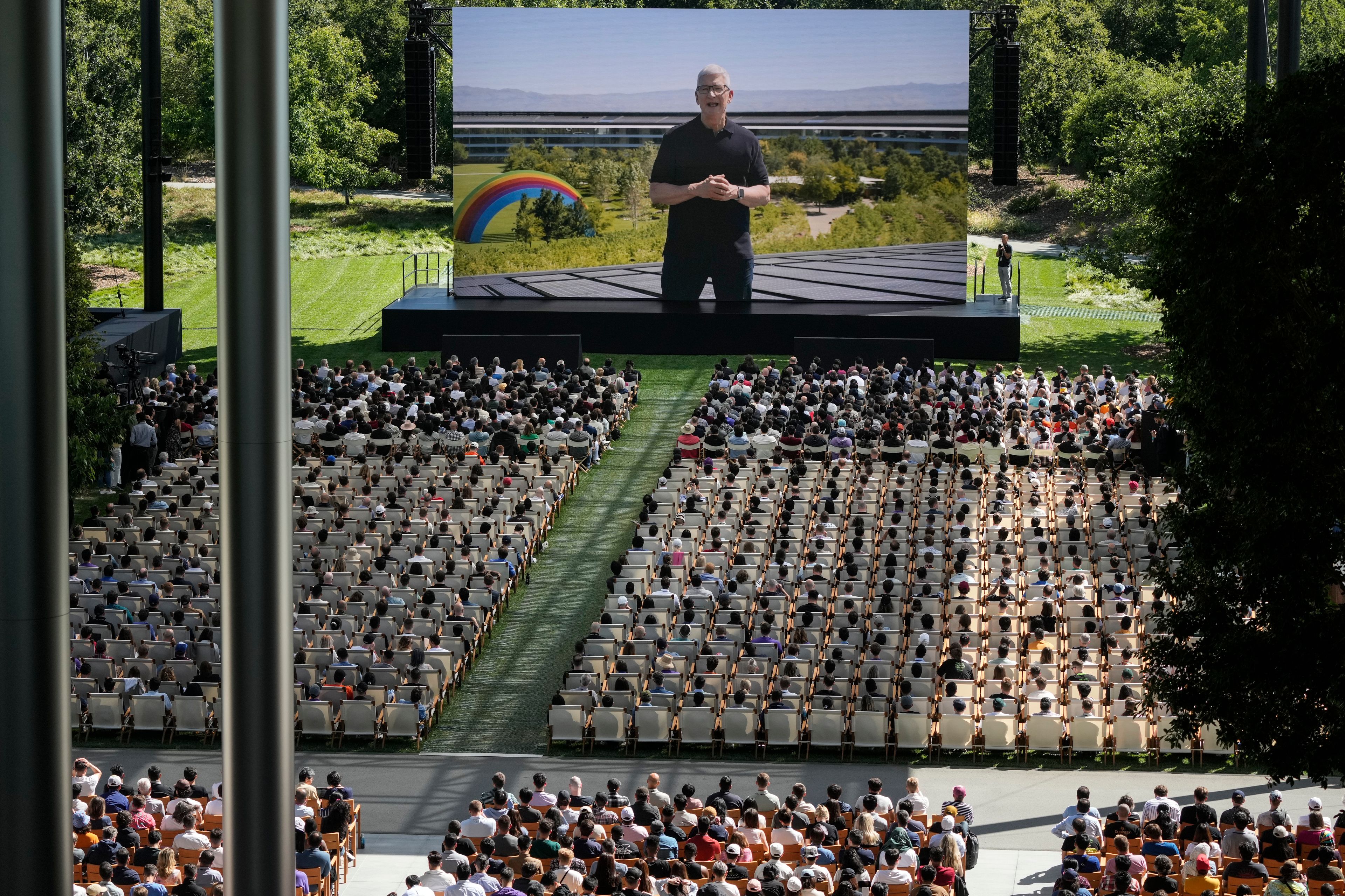 A large screen shows Apple CEO Tim Cook during an announcement of new products on the Apple campus in Cupertino, Calif., Monday, June 10, 2024.