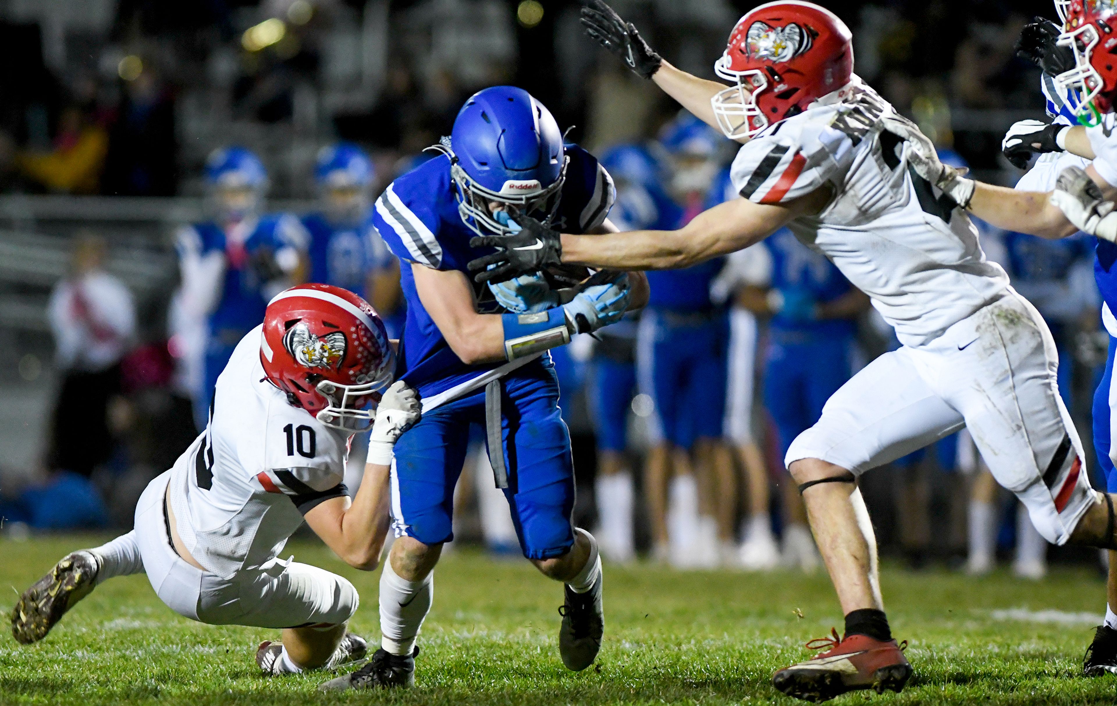 Clarkstons Traysen Hagen, left, and Milo Kunnap tackle Pullmans Brady Coulter Friday in Pullman.,