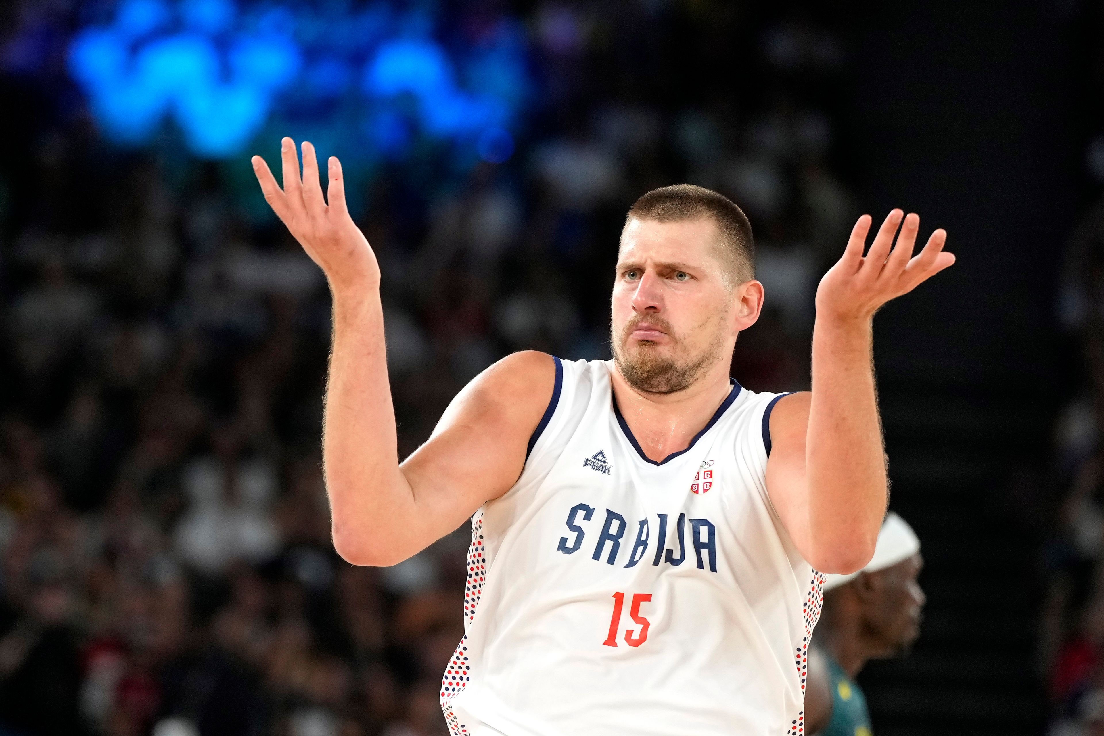 Serbia's Nikola Jokic questions a call during a men's quarterfinal game against Australia at Bercy Arena at the 2024 Summer Olympics, Tuesday, Aug. 6, 2024, in Paris, France. (AP Photo/Michael Conroy)