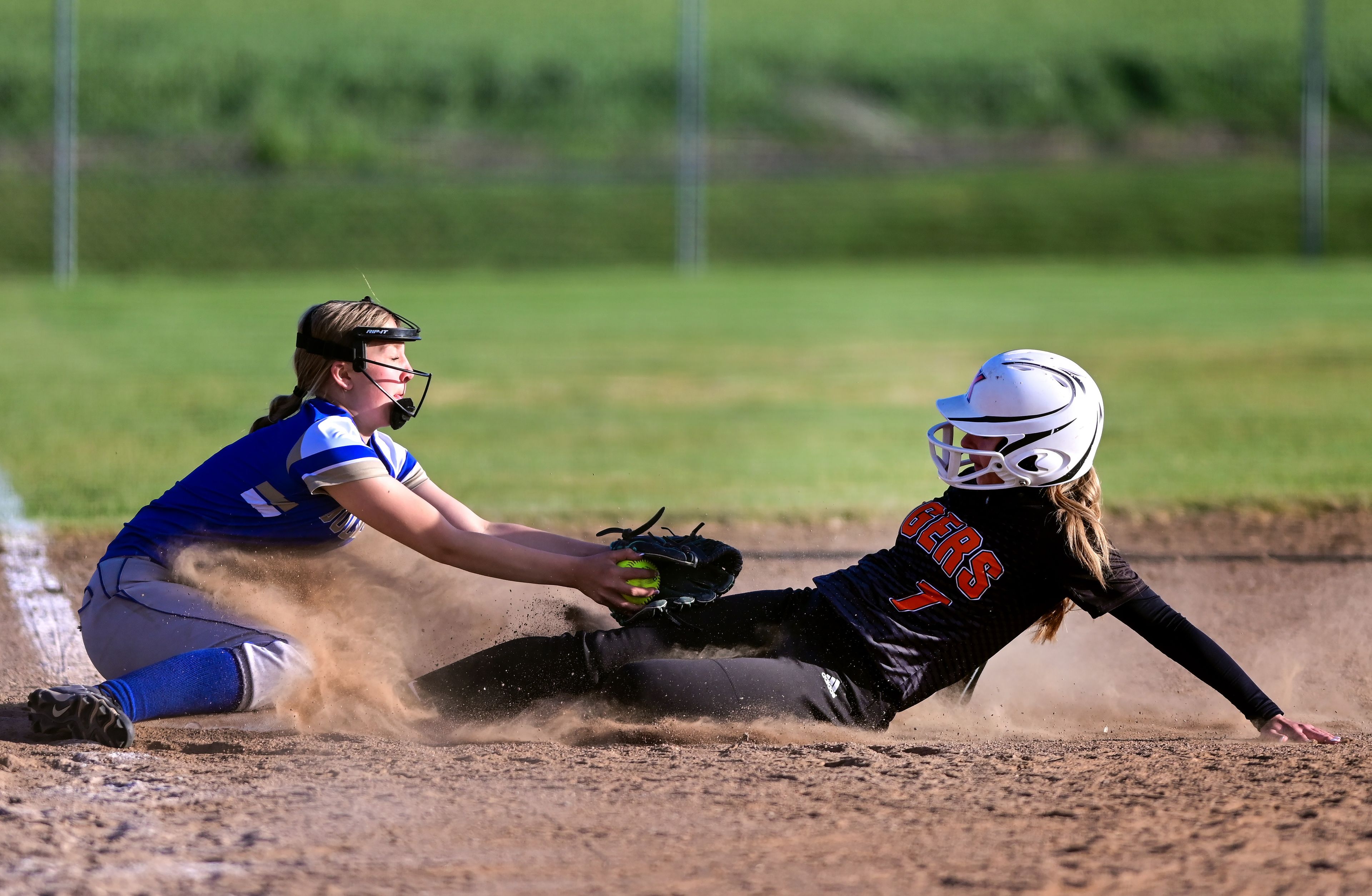 Kendrick’s Madelyn Proctor slides into third base before being tagged out by Genesee’s Sydney Banks during an Idaho 2A district tournament championship game Wednesday in Genesee.