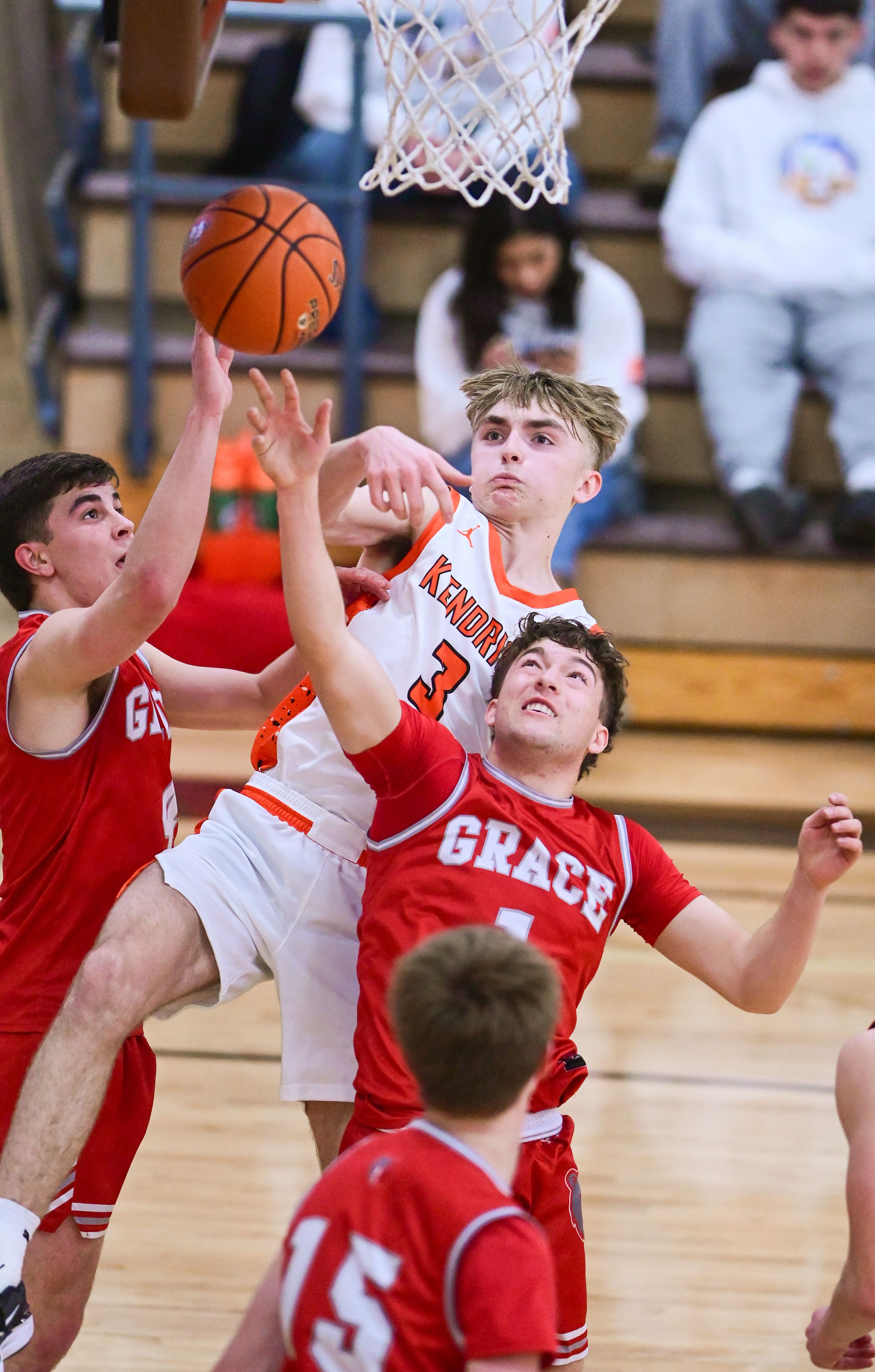 Kendrick's Kolt Koepp fights for control of a rebound ball against Grace's Braden Kimball, left, and Grace's Derek Hill at the Tigers’ net at the Idaho 2A state tournament on Friday in Caldwell, Idaho.