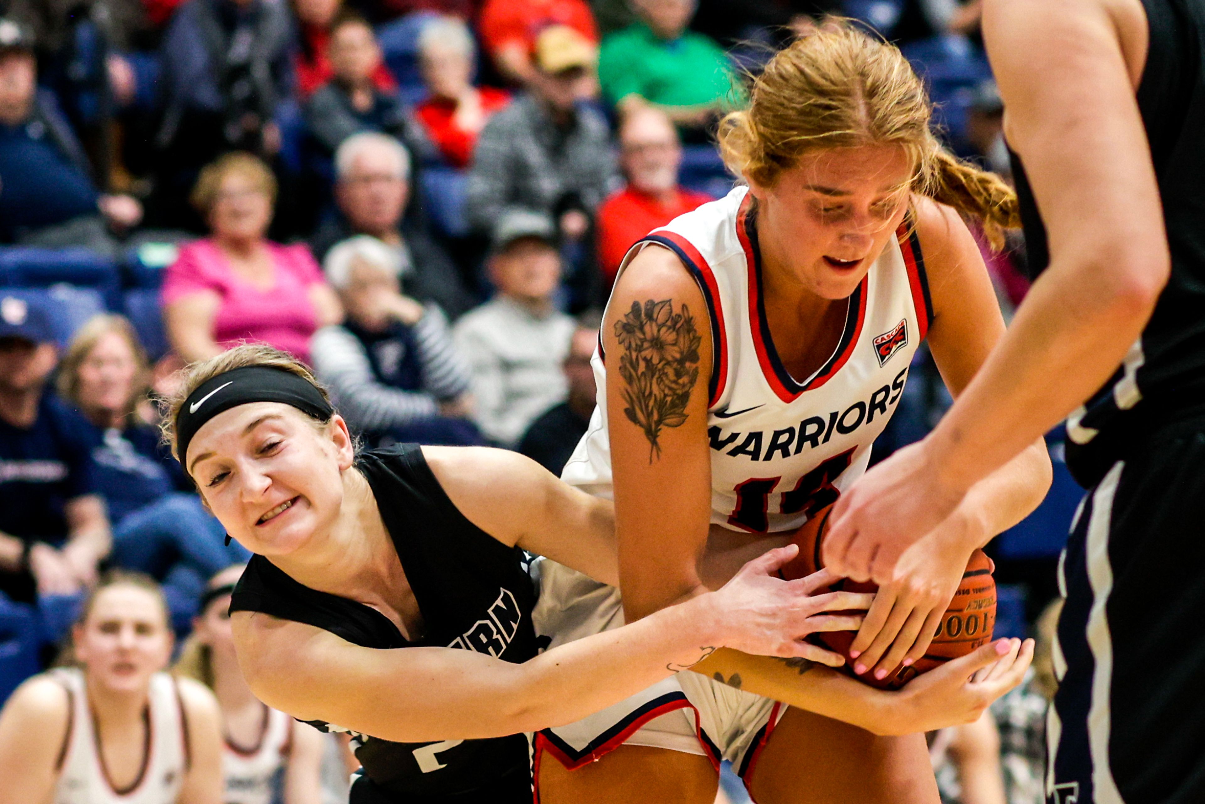 Lewis-Clark State forward Maddie Holm fights with Eastern Oregon guard Sailor Liefke for the ball during a Cascade Conference game Friday at Lewis-Clark State College.