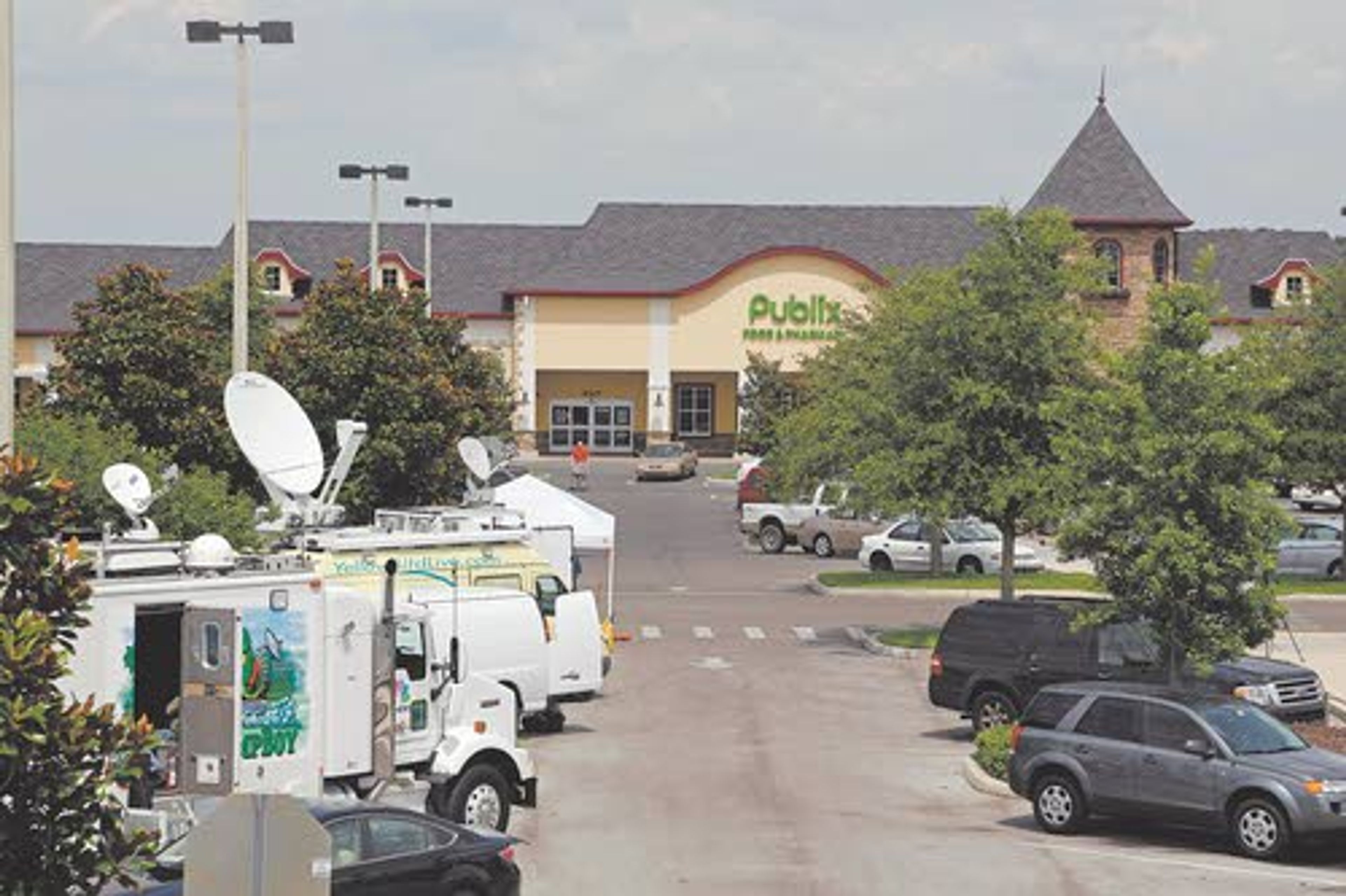 Satellite trucks are parked May 19 outside a supermarket where the highest Powerball jackpot ticket, worth an estimated $590.5 million, was sold in Zephyrhills, Fla.