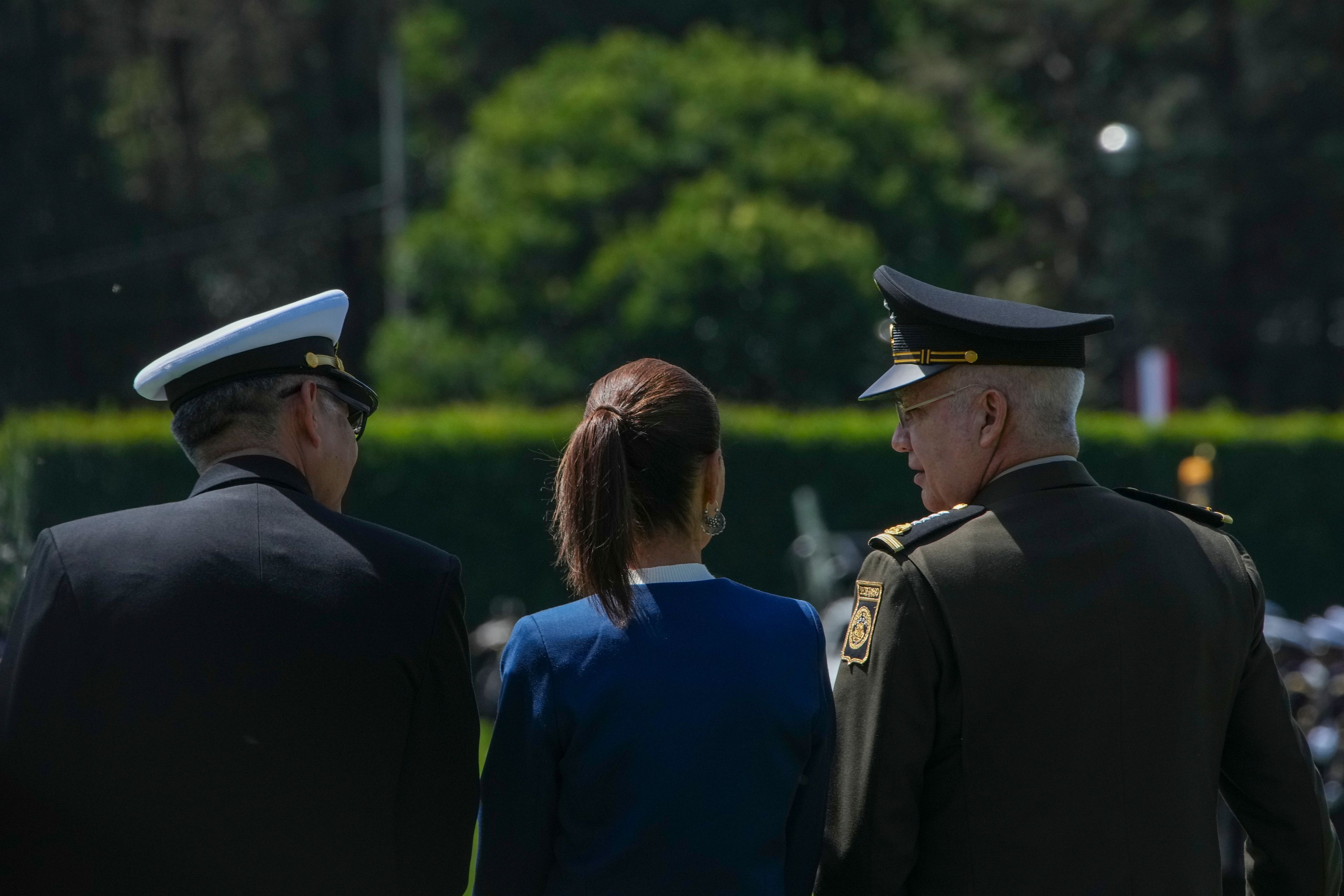 Mexican President Claudia Sheinbaum, center, reviews the troops with Defense Minister Gen. Ricardo Trevilla Trejo, right, and Navy Secretary Alt. Raymundo Pedro Morales at Campo Marte in Mexico City, Thursday, Oct. 3, 2024. (AP Photo/Fernando Llano)