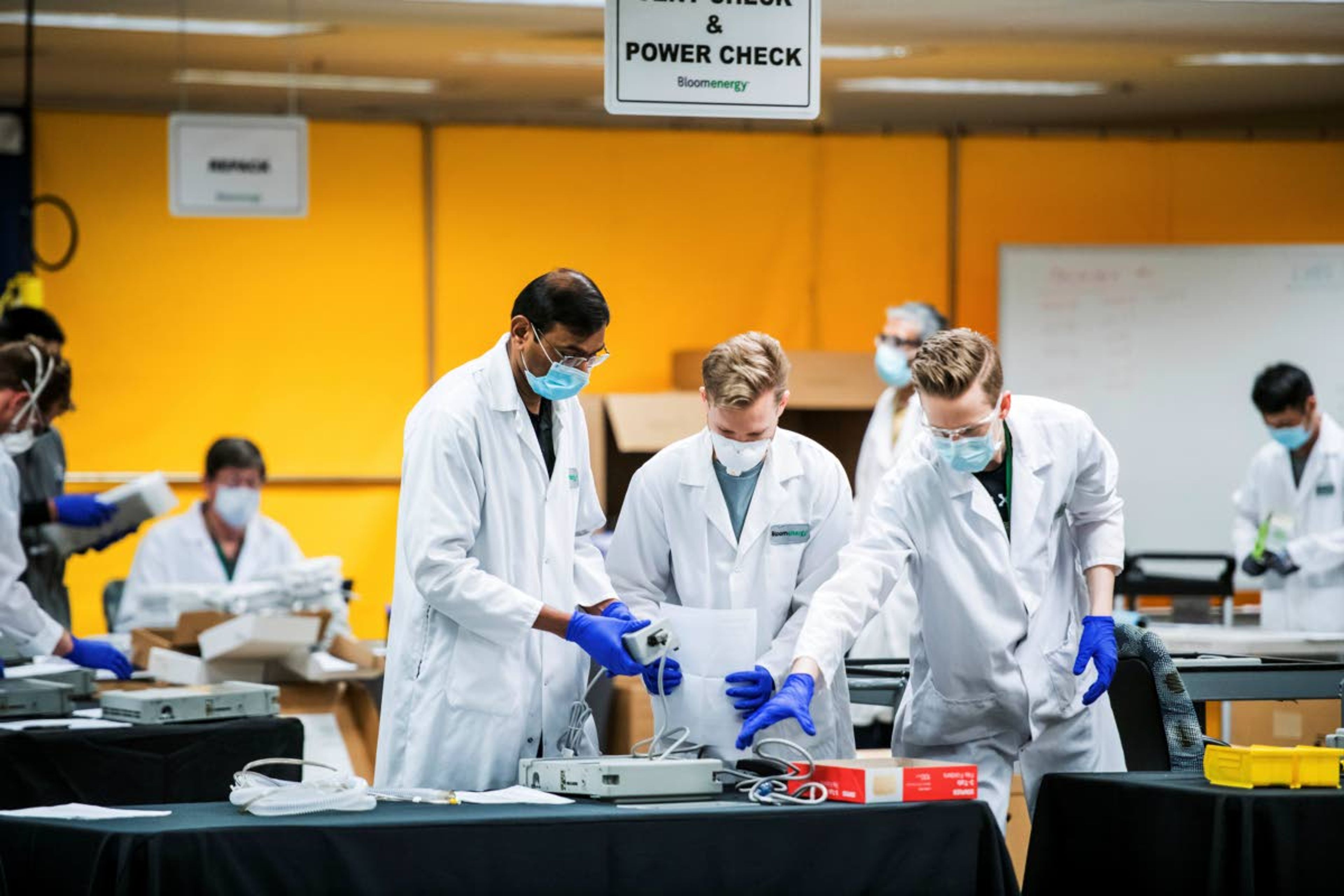 Staff work in a ventilator refurbishing assembly line March 28 at Bloom Energy in Sunnyvale, Calif.