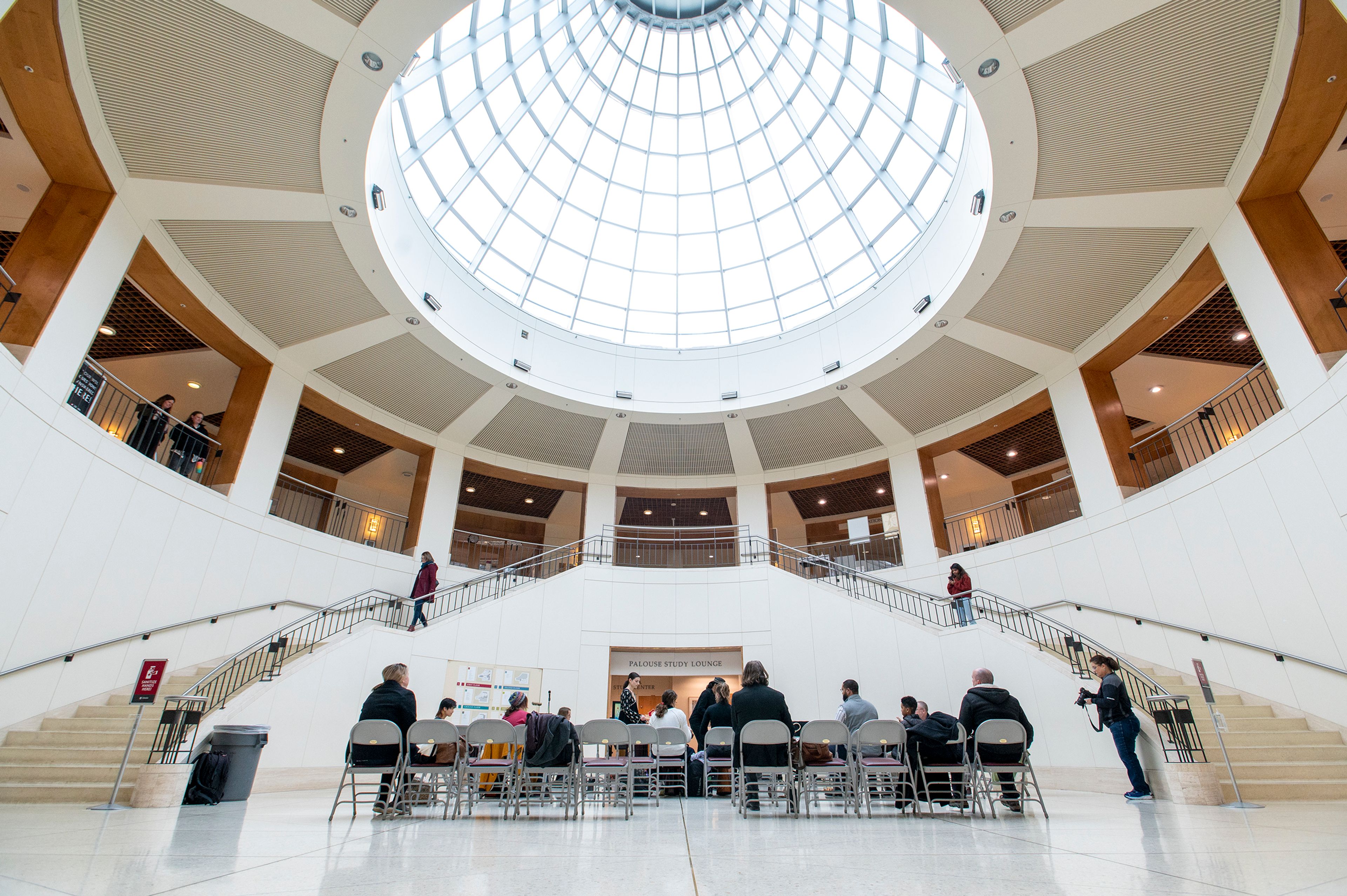 Visitors gather to listen and participate in a drum circle Tuesday at Washington State University’s Terrell Library Atrium in Pullman for the National Day of Racial Healing.