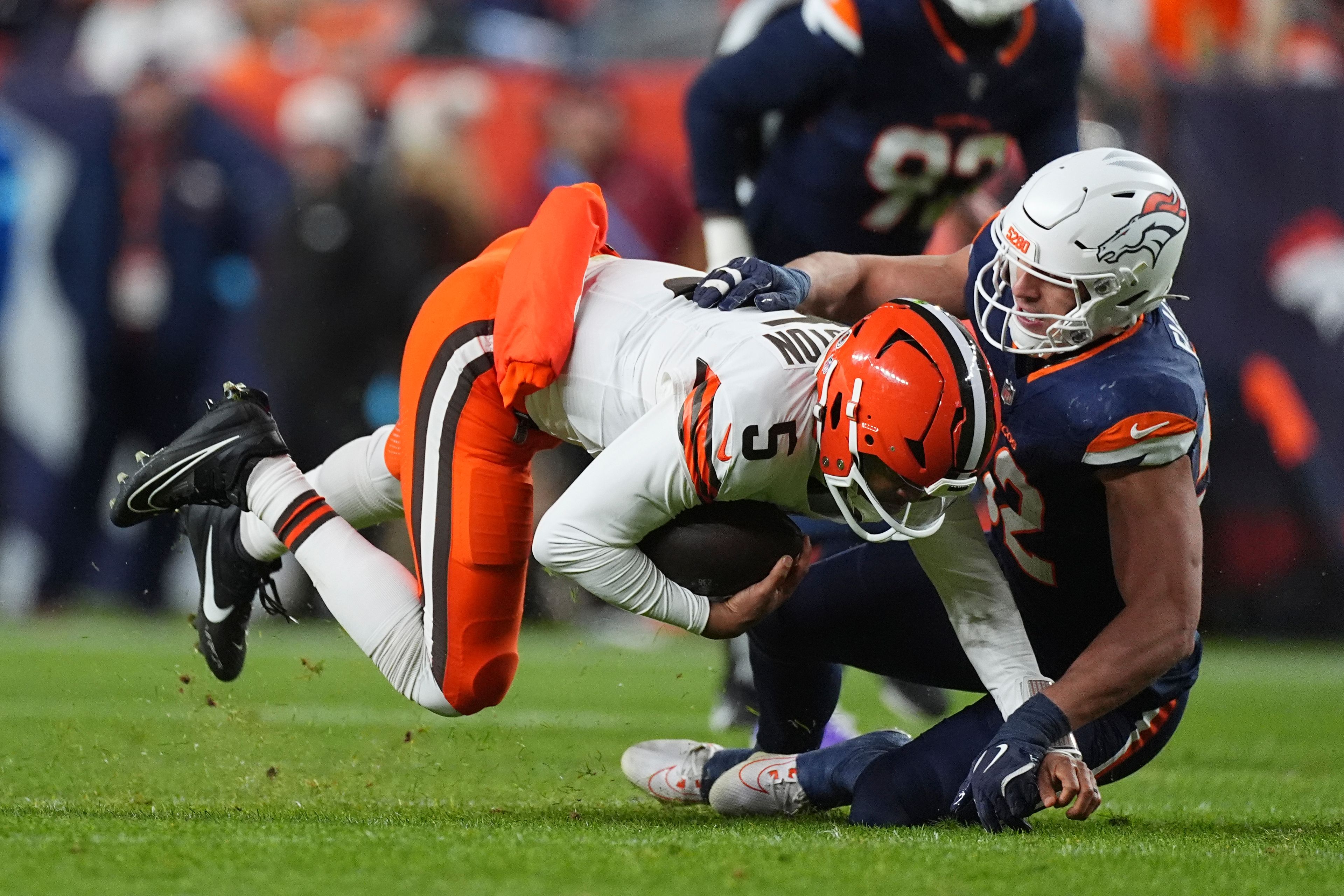 Cleveland Browns quarterback Jameis Winston (5) is tackled by Denver Broncos linebacker Jonah Elliss during the first half of an NFL football game, Monday, Dec. 2, 2024, in Denver. (AP Photo/David Zalubowski)