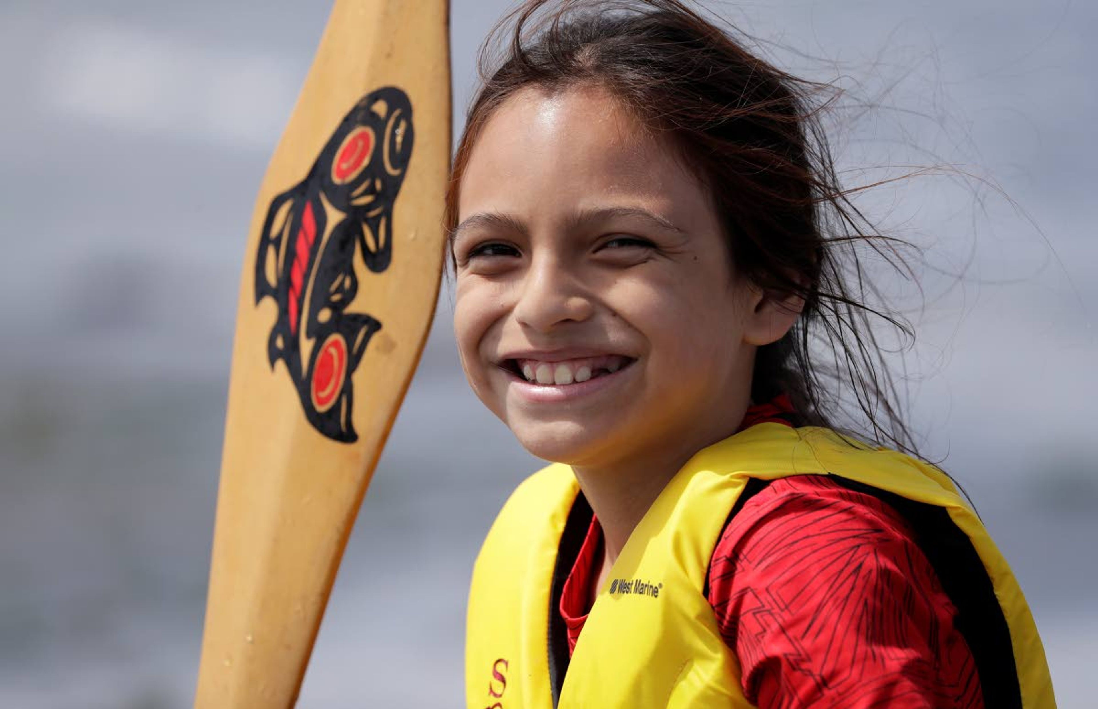 Cayuse McCloud, a Puyallup tribal member, smiles as he steps ashore after pulling during a stop on the annual tribal canoe journey through the Salish Sea Thursday, July 18, 2019, in Seattle. About 20 canoes from Northwest Native coastal tribes landed Thursday at Alki Beach on one of several legs of the canoe journey that gathers other canoe families from host tribes as they travel to a final landing, this year near Bellingham, Wash., at the Lummi Nation. (AP Photo/Elaine Thompson)