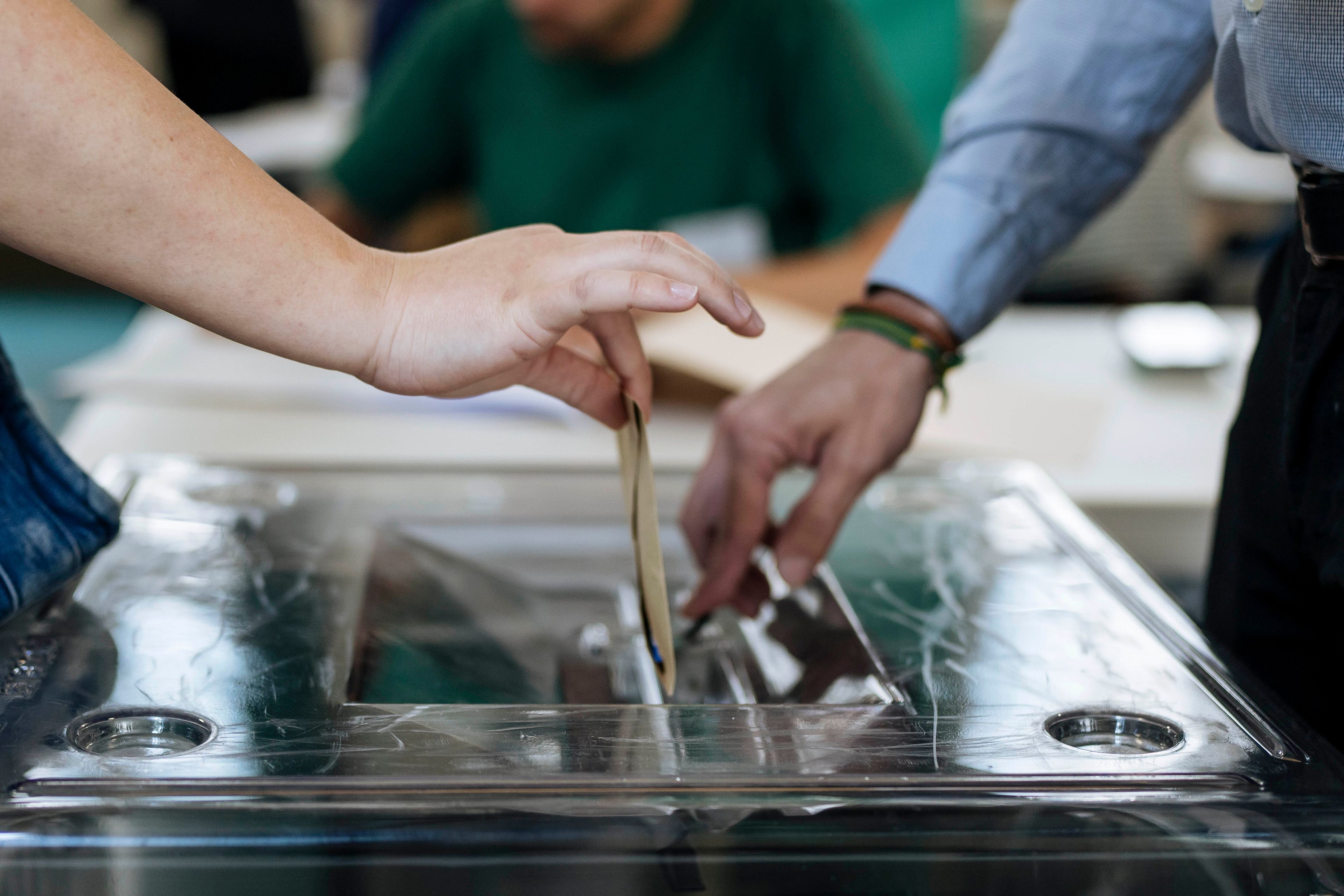 A woman, left, casts her ballot for the European Parliament election, Sunday, June 9, 2024 in Paris. Polling stations opened across Europe on Sunday as voters from 20 countries cast ballots in elections that are expected to shift the European Union's parliament to the right and could reshape the future direction of the world's biggest trading bloc.