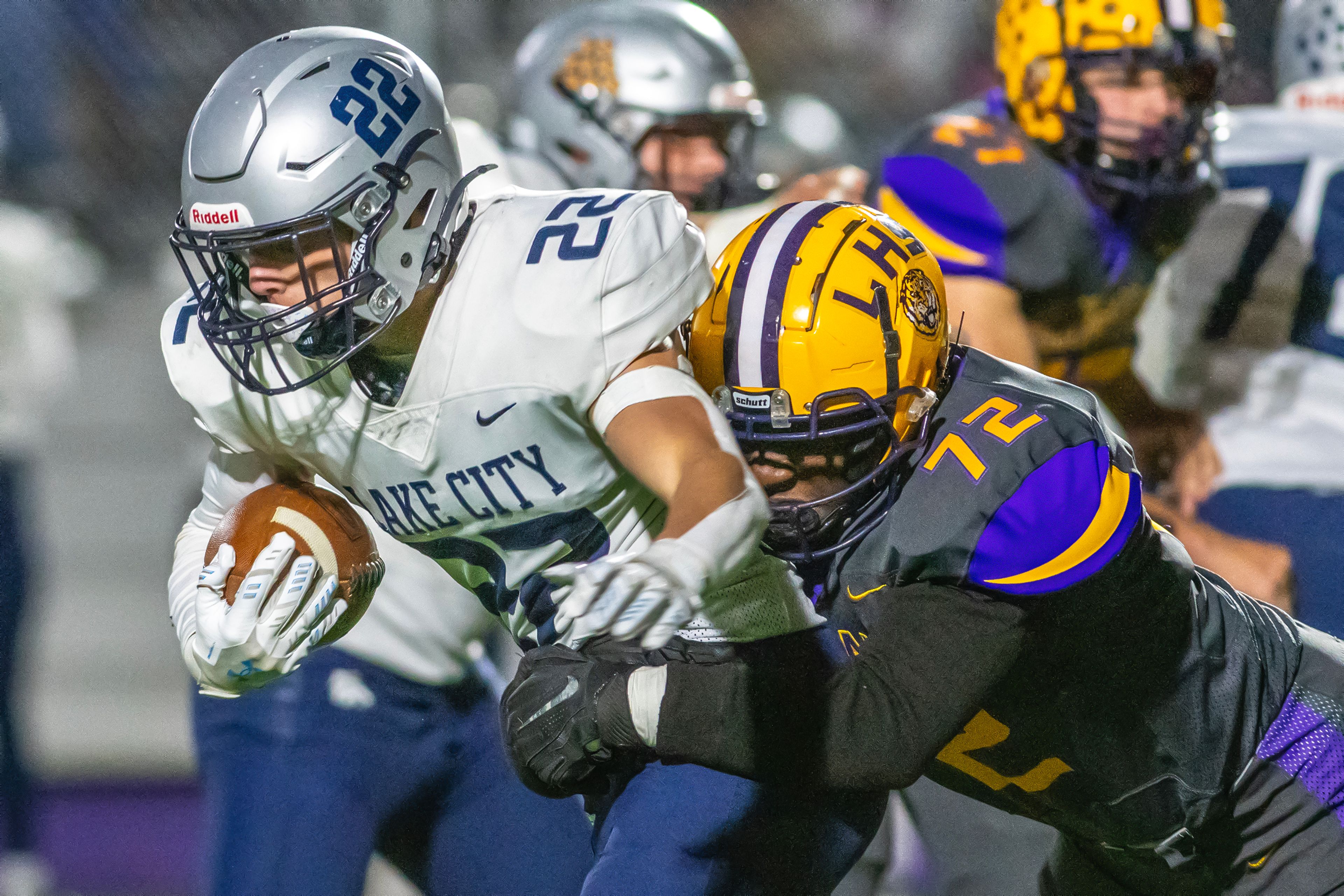 Lewiston defensive lineman Parker Bagley tackles Lake City running back Gabe Wullenwaber in a nonconference game Friday at Lewiston High School.,