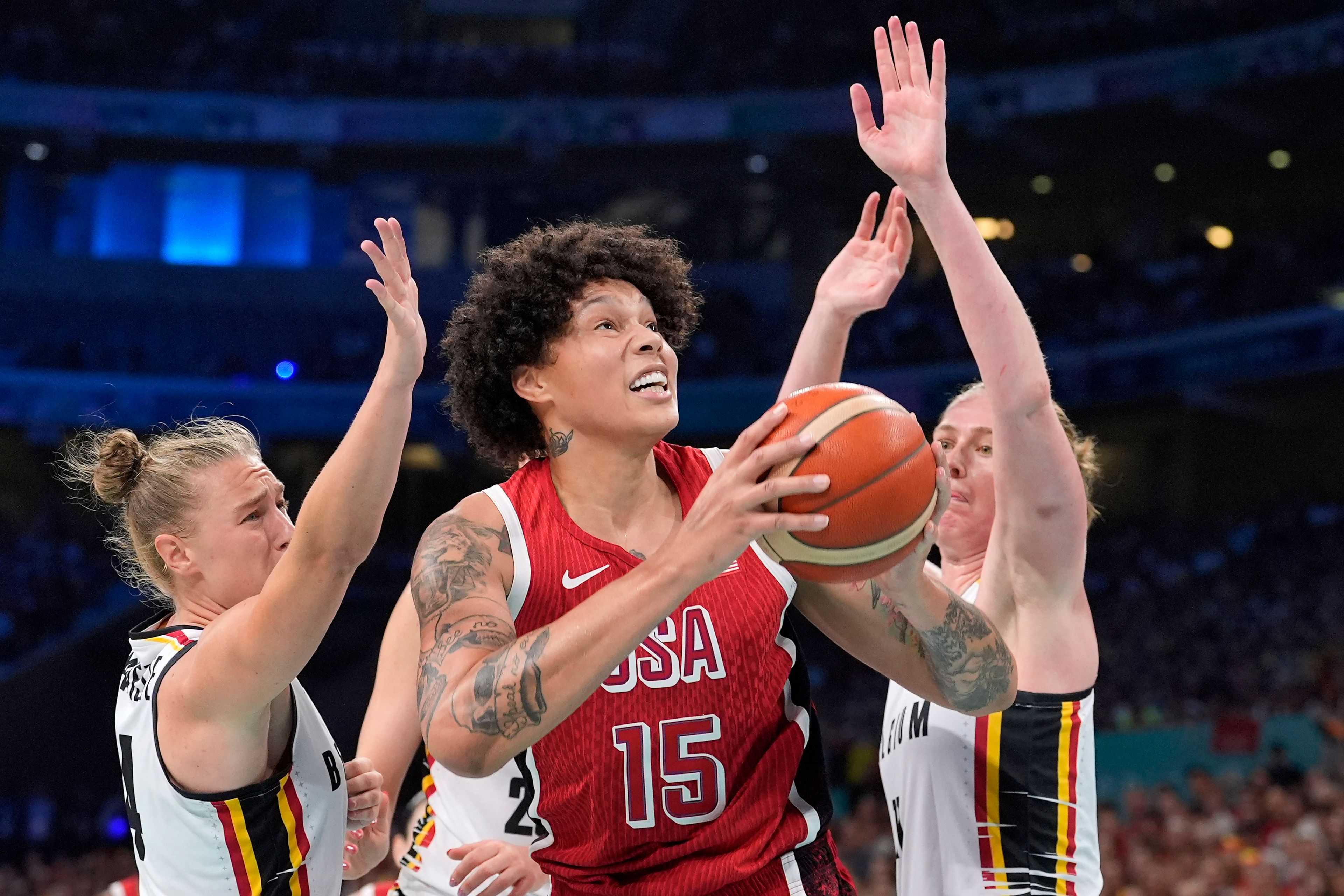 United States' Brittney Griner, center, shoots as Belgium's Elisa Ramette and Belgium's Emma Meesseman defend during a women's basketball game at the 2024 Summer Olympics, Thursday, Aug. 1, 2024, in Villeneuve-d'Ascq, France. (AP Photo/Michael Conroy)