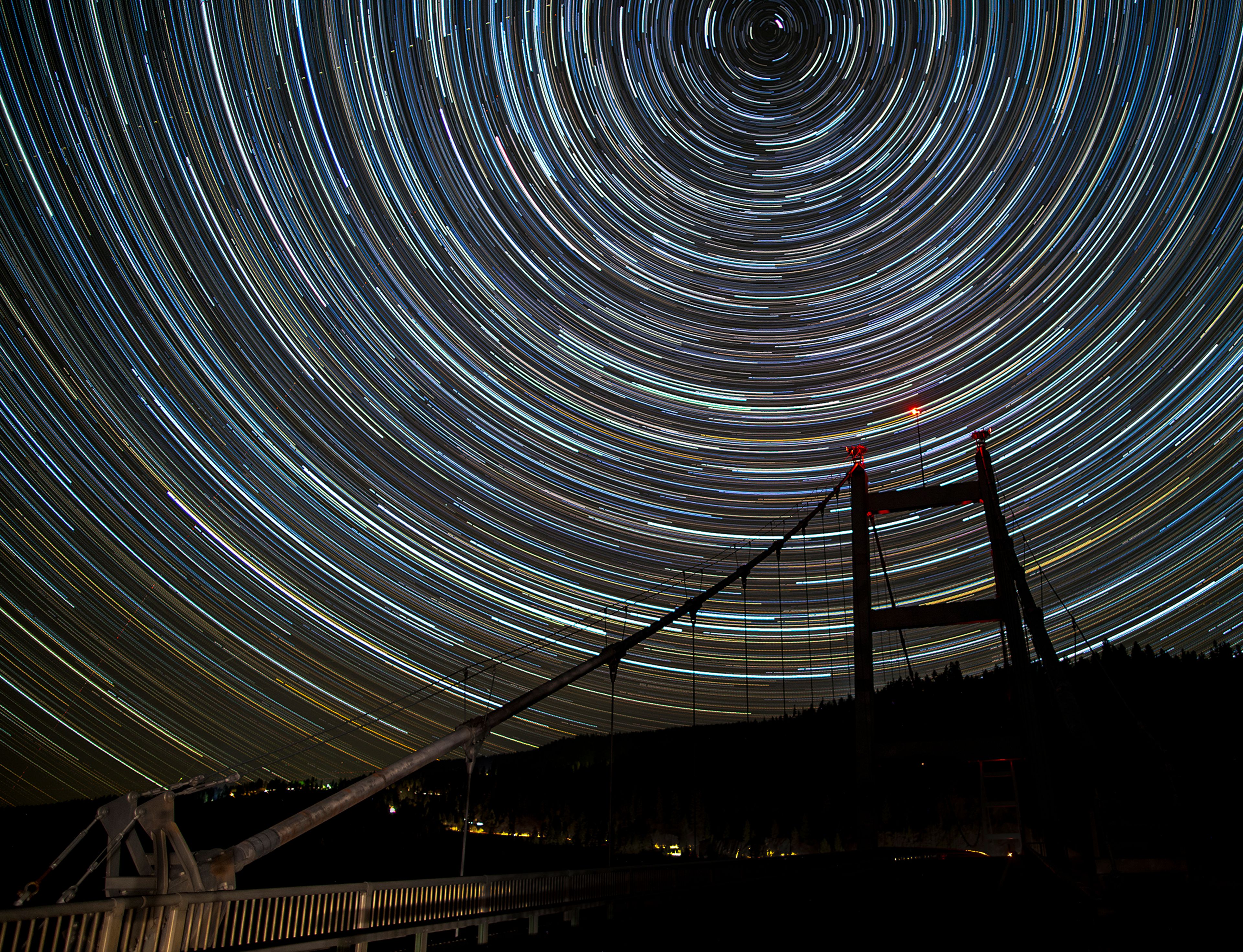 Star trials spiral around the North Star over the Dent Bridge near Orofino on Oct. 18, 2022, The Dent Bridge is the tallest bridge in Idaho at a height of 500 feet. This photo, taken by former Lewiston Tribune photographer Austin Johnson, was created by stacking 220 images in photoshop and required spending all night with a camera on a tripod shooting images continually. The more images that go into the photo the more robust the star trails are in the final product and a dark night, without a full moon, makes for brighter stars.