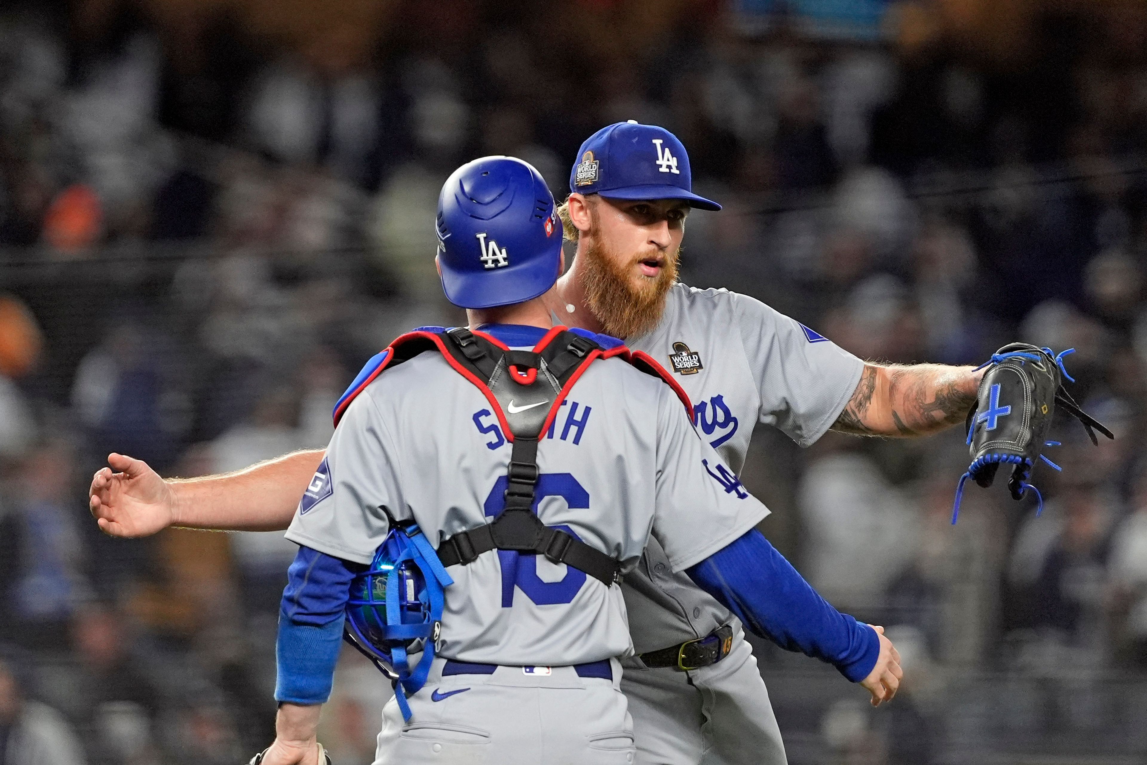 Los Angeles Dodgers' Will Smith (16) and Michael Kopech celebrate after Game 3 of the baseball World Series against the New York Yankees, Monday, Oct. 28, 2024, in New York. The Dodgers won 4-2. (AP Photo/Godofredo A. Vásquez)