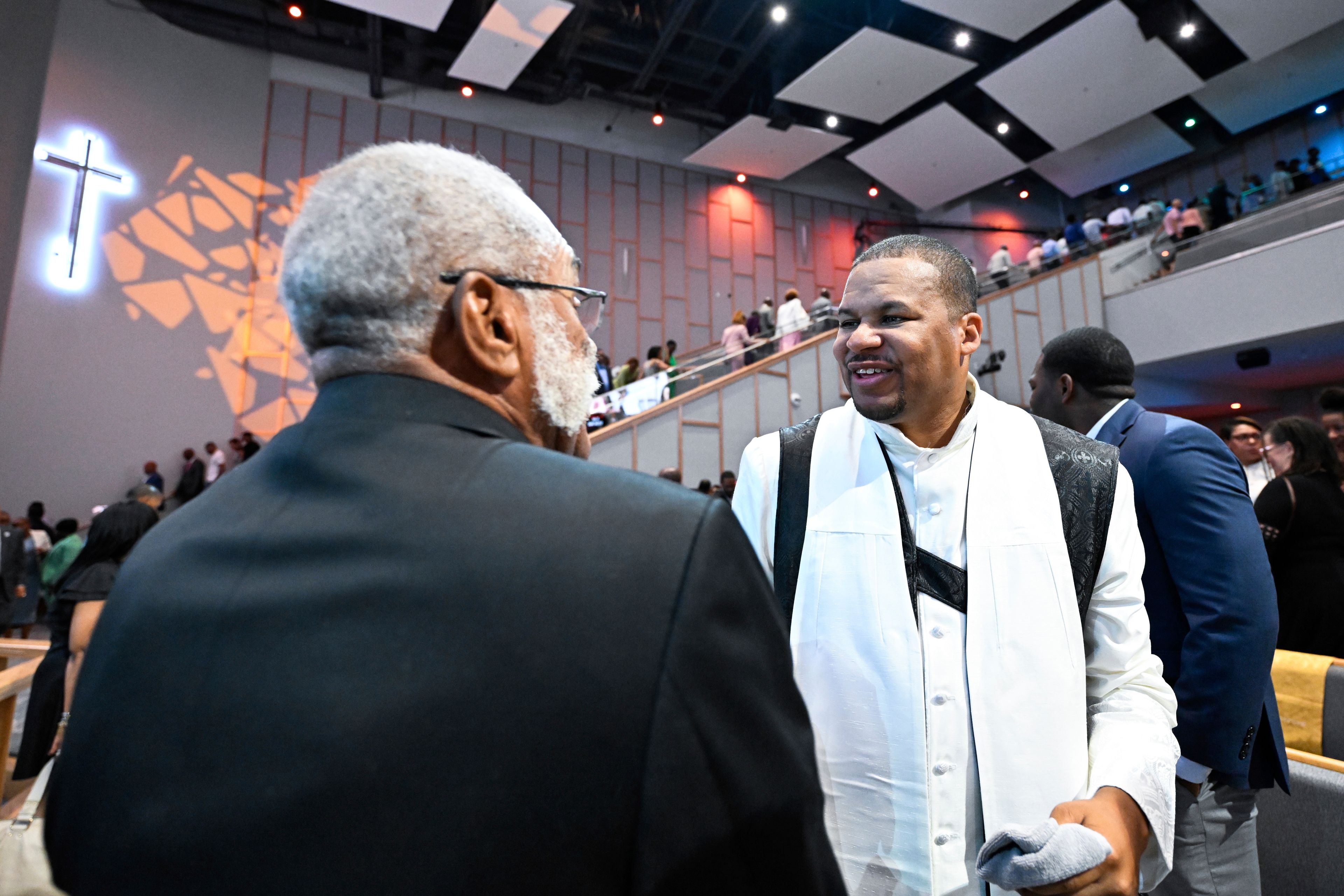 Reverend Matthew L. Watley, right, greets members of the congregation after Sunday service at Kingdom Fellowship AME Church, Sunday, June 2, 2024, in Calverton, Md. The suburban Maryland congregation, led by Rev. Watley, has landed at the top of a list of the fastest-growing churches in America.