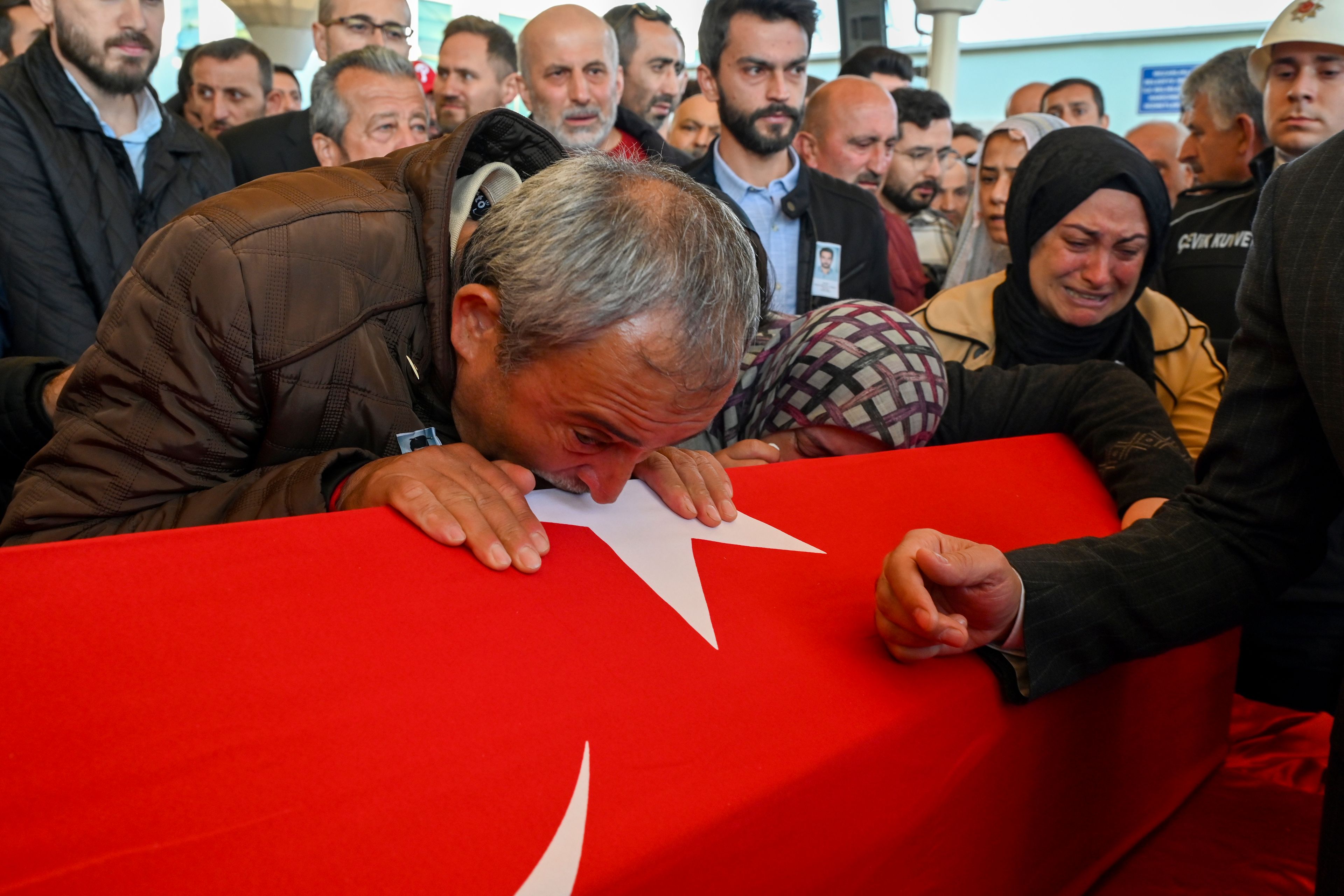 Relatives of Hasan Huseyin Canbaz, who was killed during an attack by PKK members at the Turkish aerospace and defense company TUSAS in Ankara on Wednesday, mourn during a funeral at Karsiyaka mosque in Ankara, Thursday, Oct. 24, 2024. (AP Photo/Ali Unal)