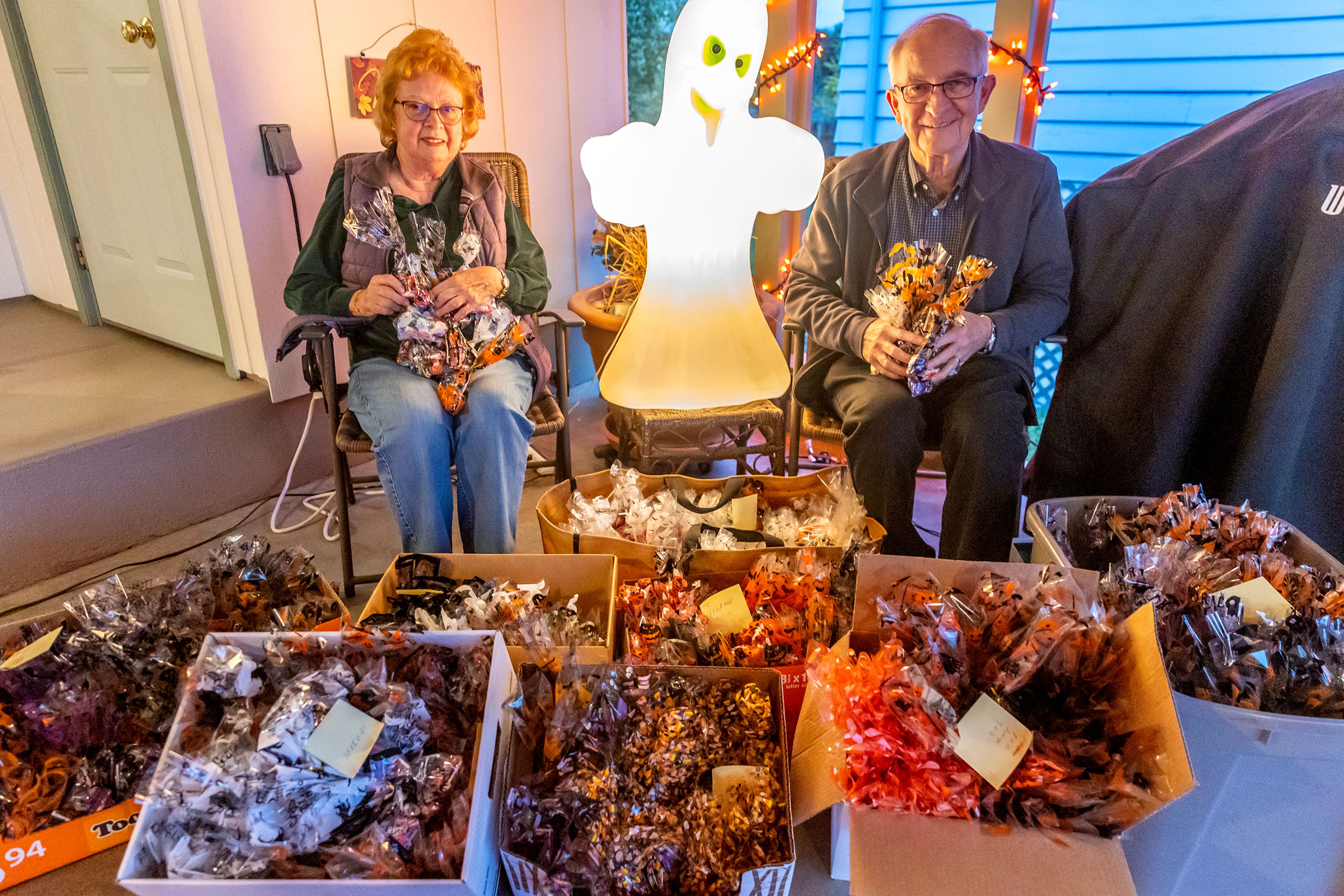 Mike and Sharon Ripley pose for a photo with their 900 bags of candy, which themselves contain multiple individual pieces, at their home Thursday in the Sunset neighborhood in Lewiston.