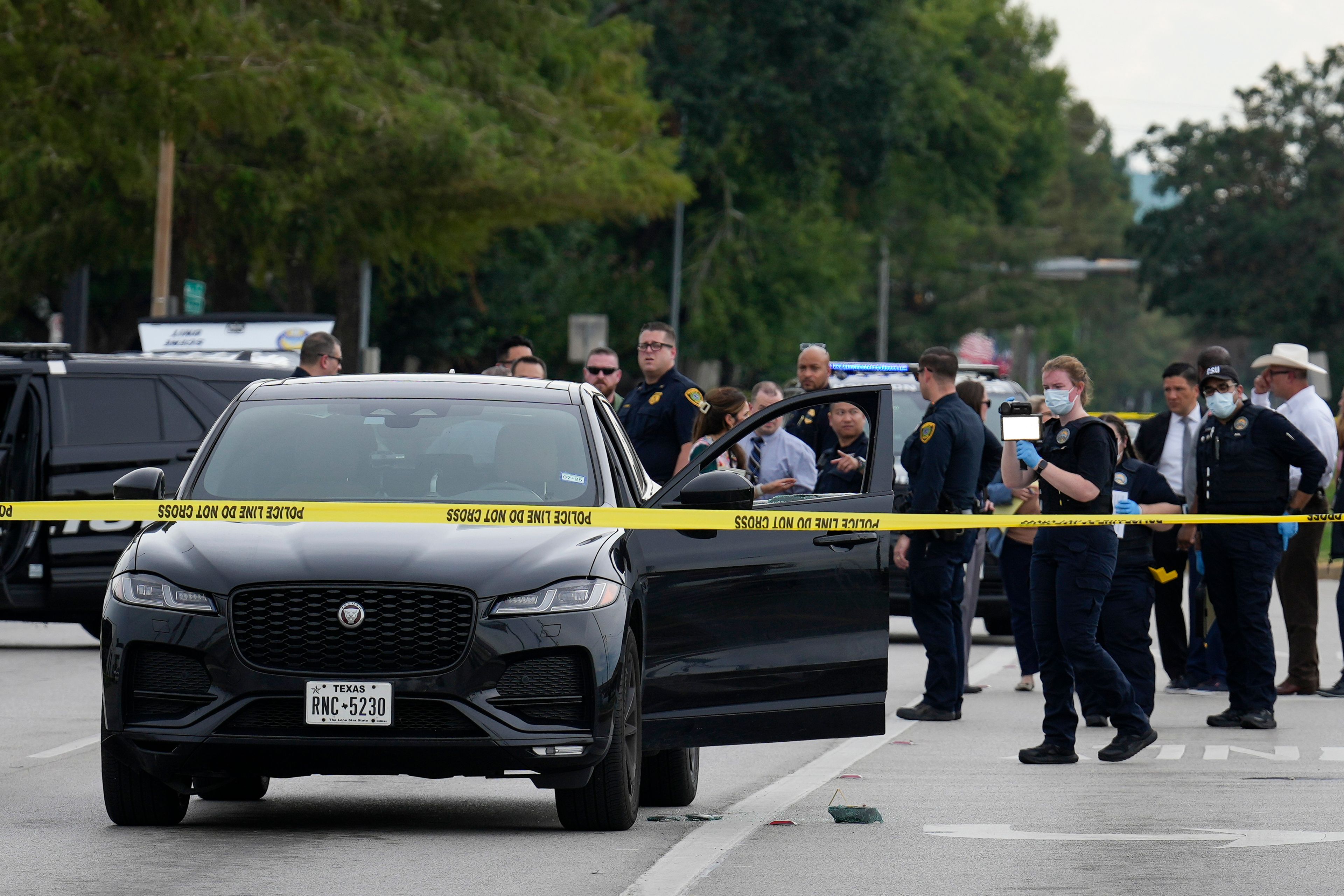 A Houston Forensic Science Center Crime Scene Unit member investigates the scene after Harris County deputy constable Maher Husseini was shot and killed Tuesday, Sept. 3, 2024, in Houston.