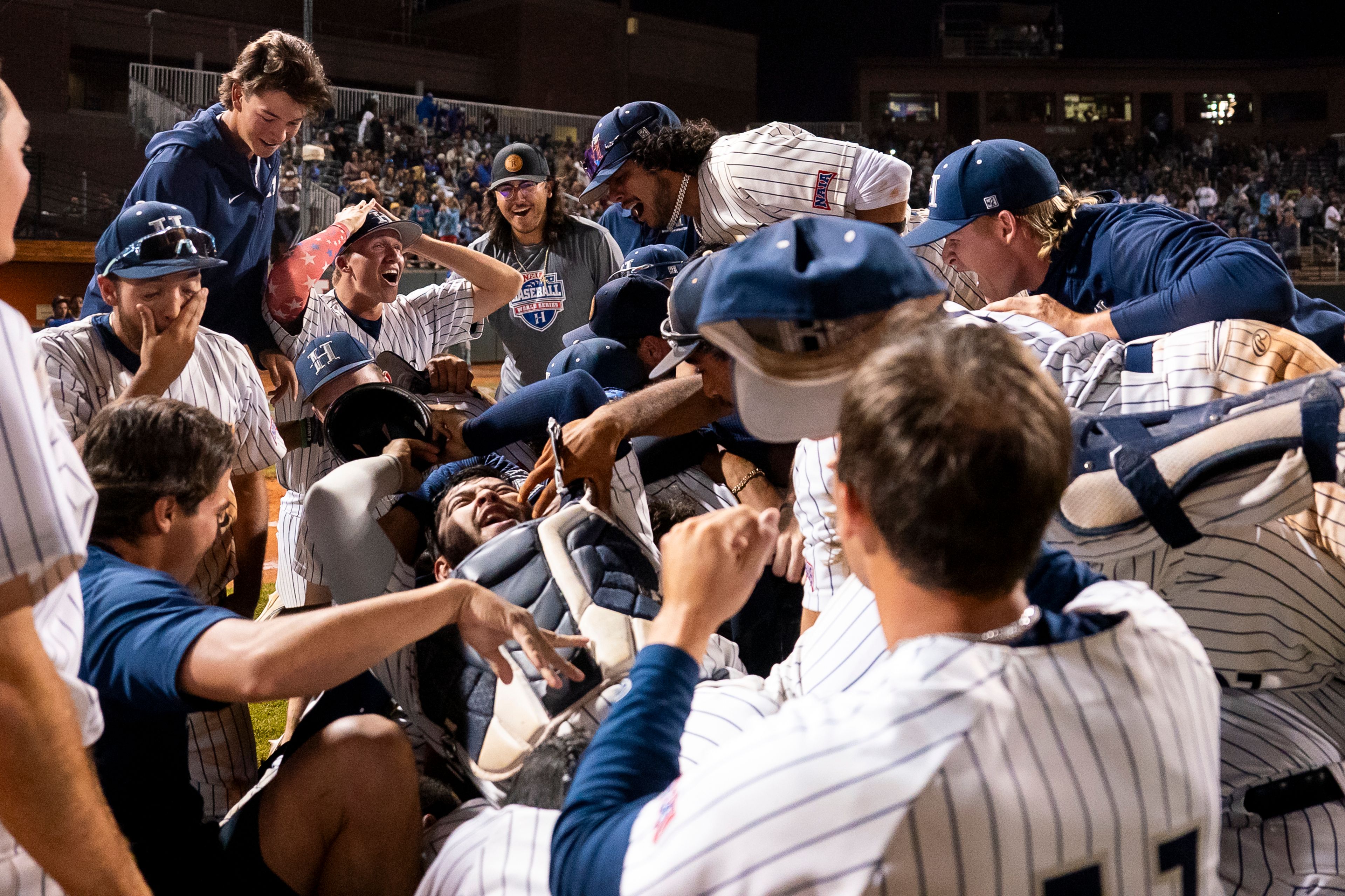 Hope International players celebrate after winning Game 19 of the NAIA World Series against Tennessee Wesleyan on Friday at Harris Field in Lewiston.