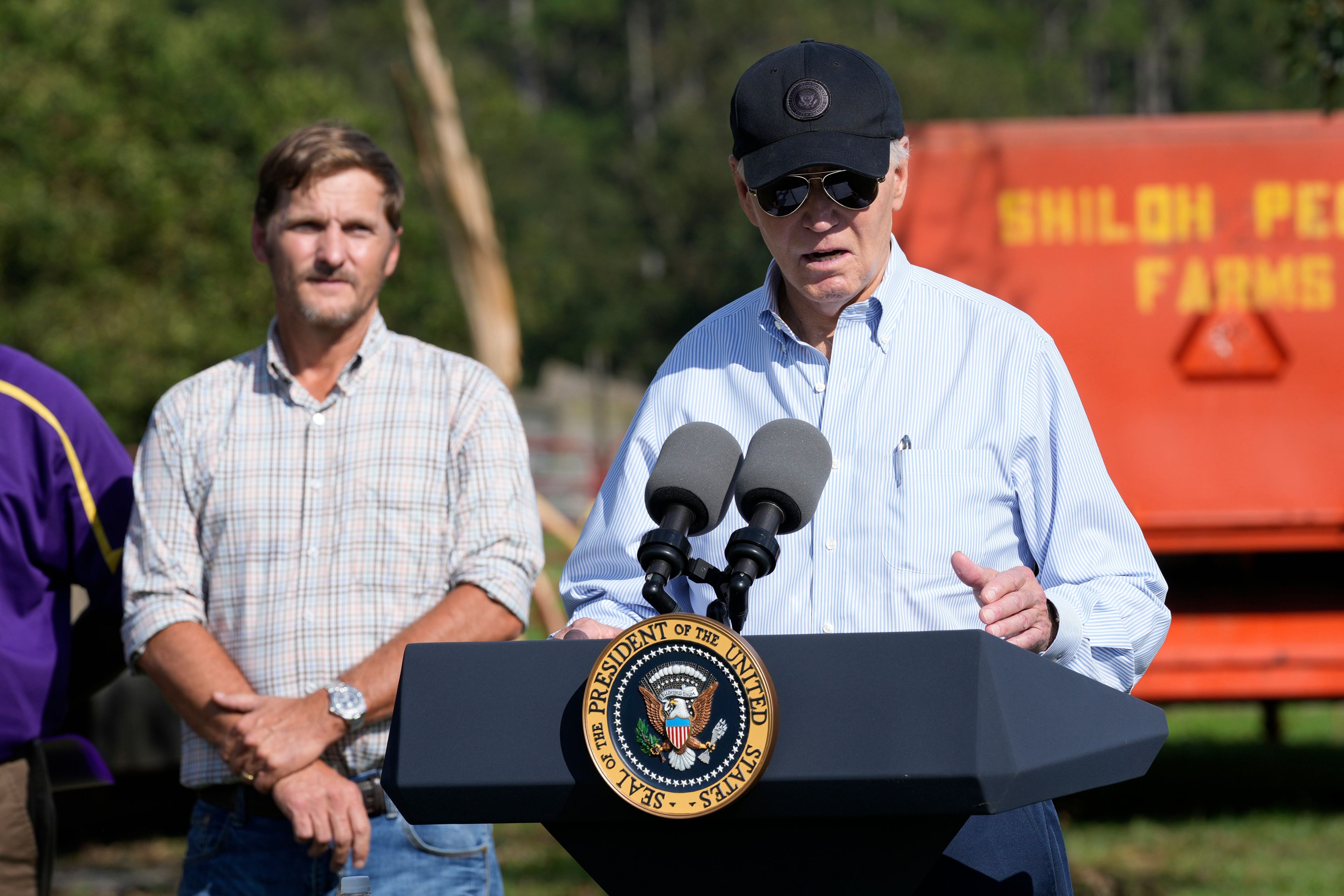 President Joe Biden speaks at Shiloh Pecan Farm as property manager Buck Paulk looks on in Ray City, Ga., Thursday, Oct. 3, 2024, as part of Biden's trip to see areas impacted by Hurricane Helene. (AP Photo/Susan Walsh)