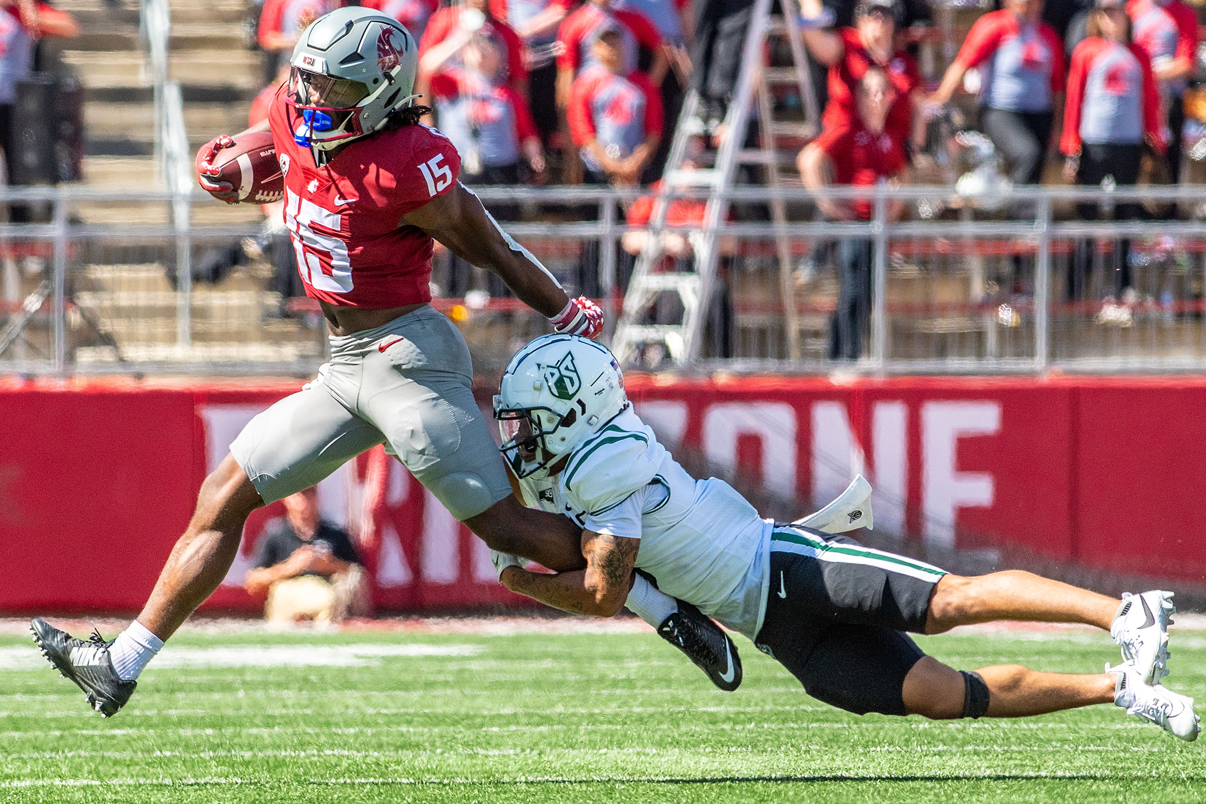 Washington State running back Djouvensky Schlenbaker runs the ball as Portland State safety Tyreese Shakir grabs onto his leg during a quarter of a nonconference game at Gesa Field in Pullman.