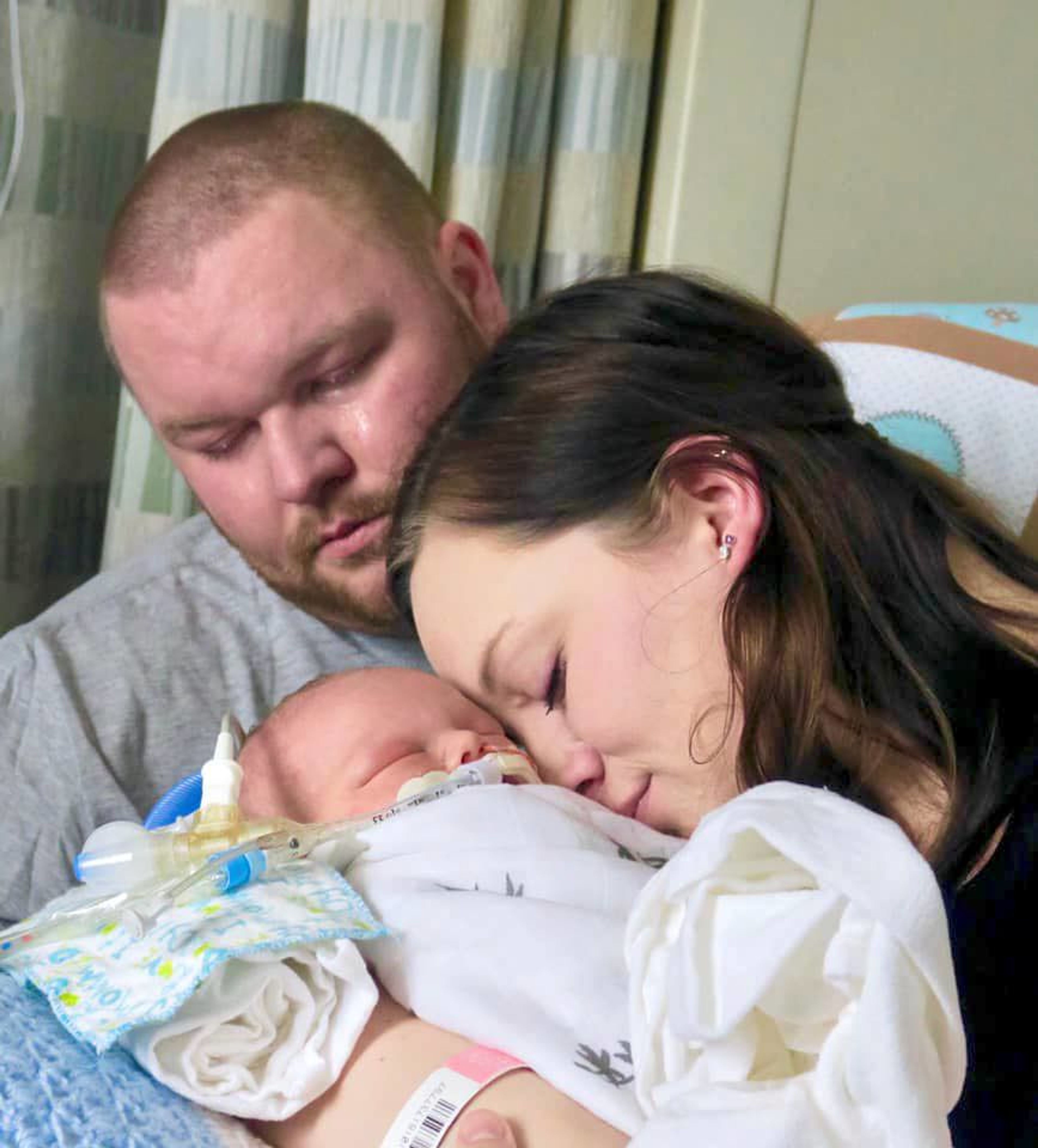 In this photo, Shelby Ward and Codi Brandt hold their infant son, Jackson Peter Ward.