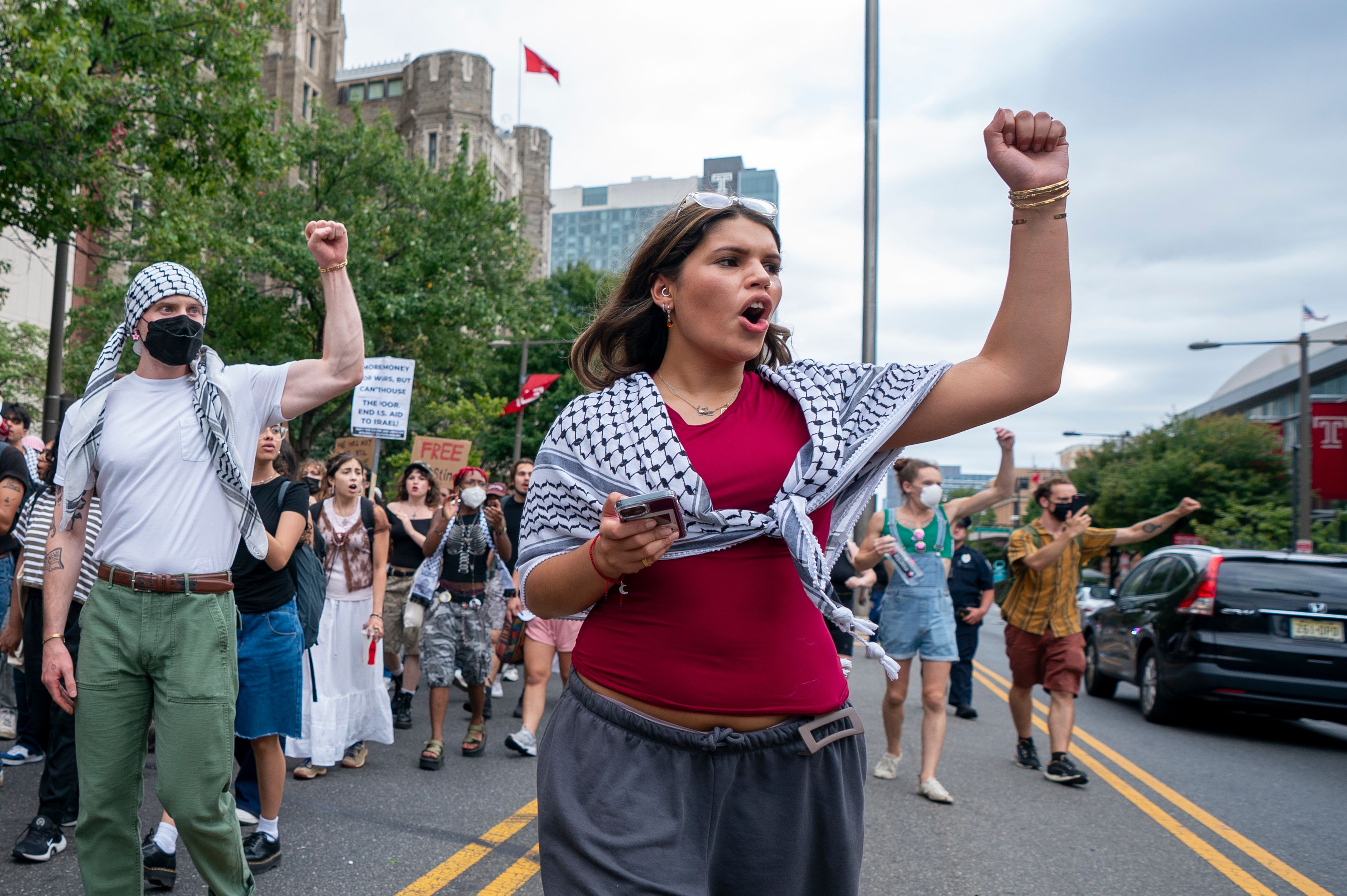 Alia Amanpour Trapp, center, reacts to car horns as she leads the crowd during a pro-Palestine rally and march on Temple University campus in Philadelphia, Aug. 29, 2024.