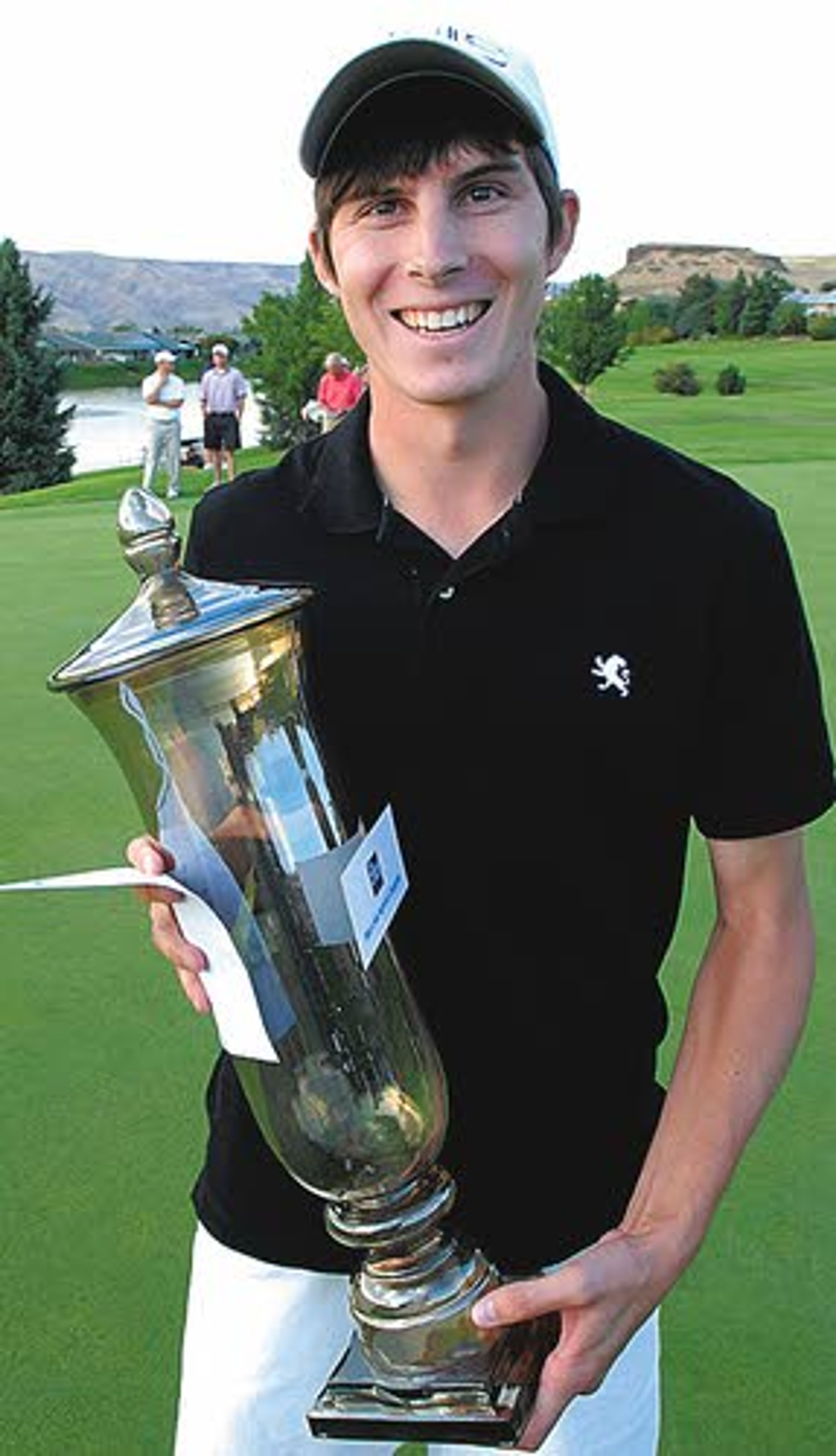 Joel Dahmen holds his Whing Ding championship trophy.