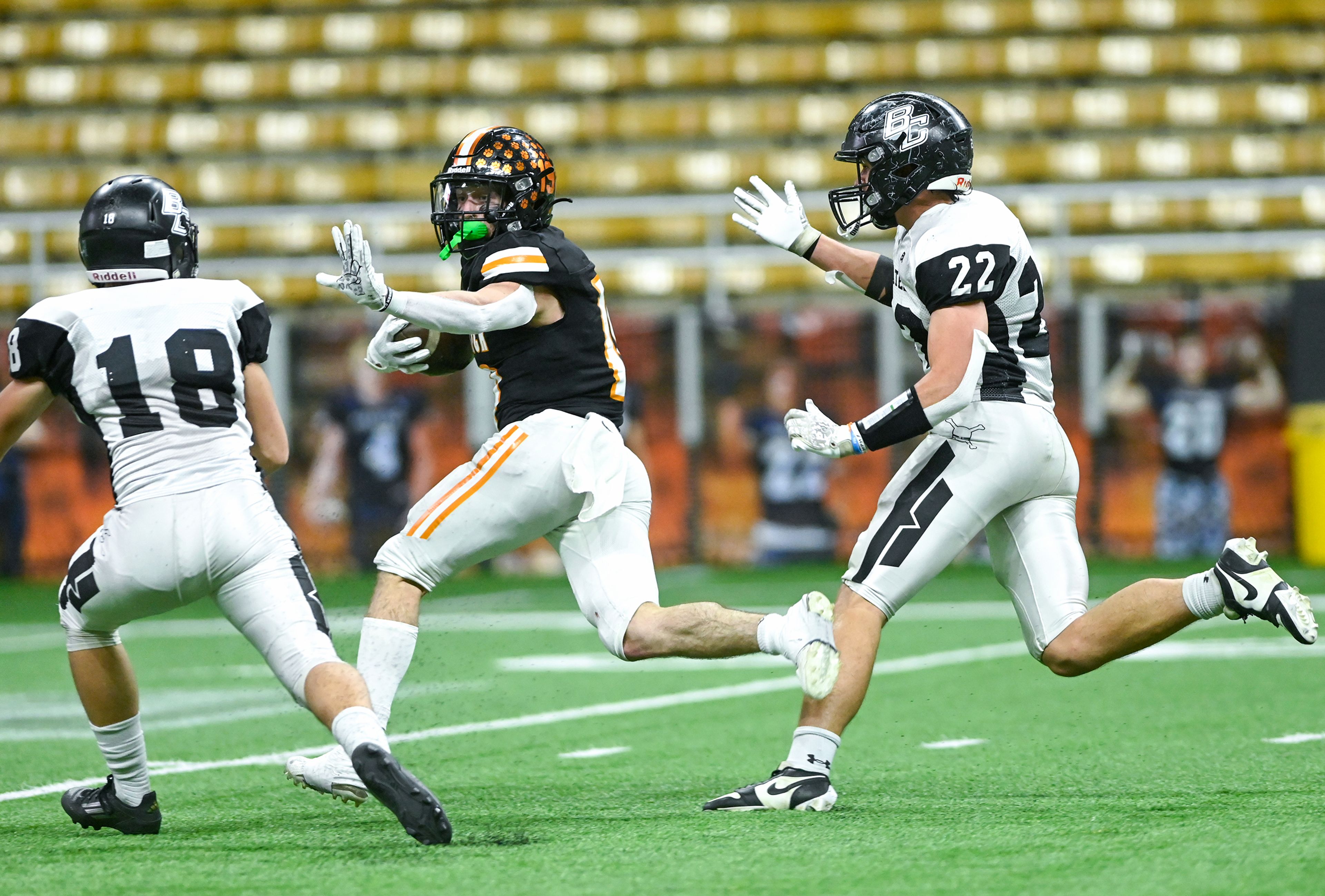 Kendrick’s Sawyer Hewett raises an arm to defend against Butte County’s Levi Hendriks Friday during the Idaho 2A football state championship game at the P1FCU Kibbie Dome in Moscow.