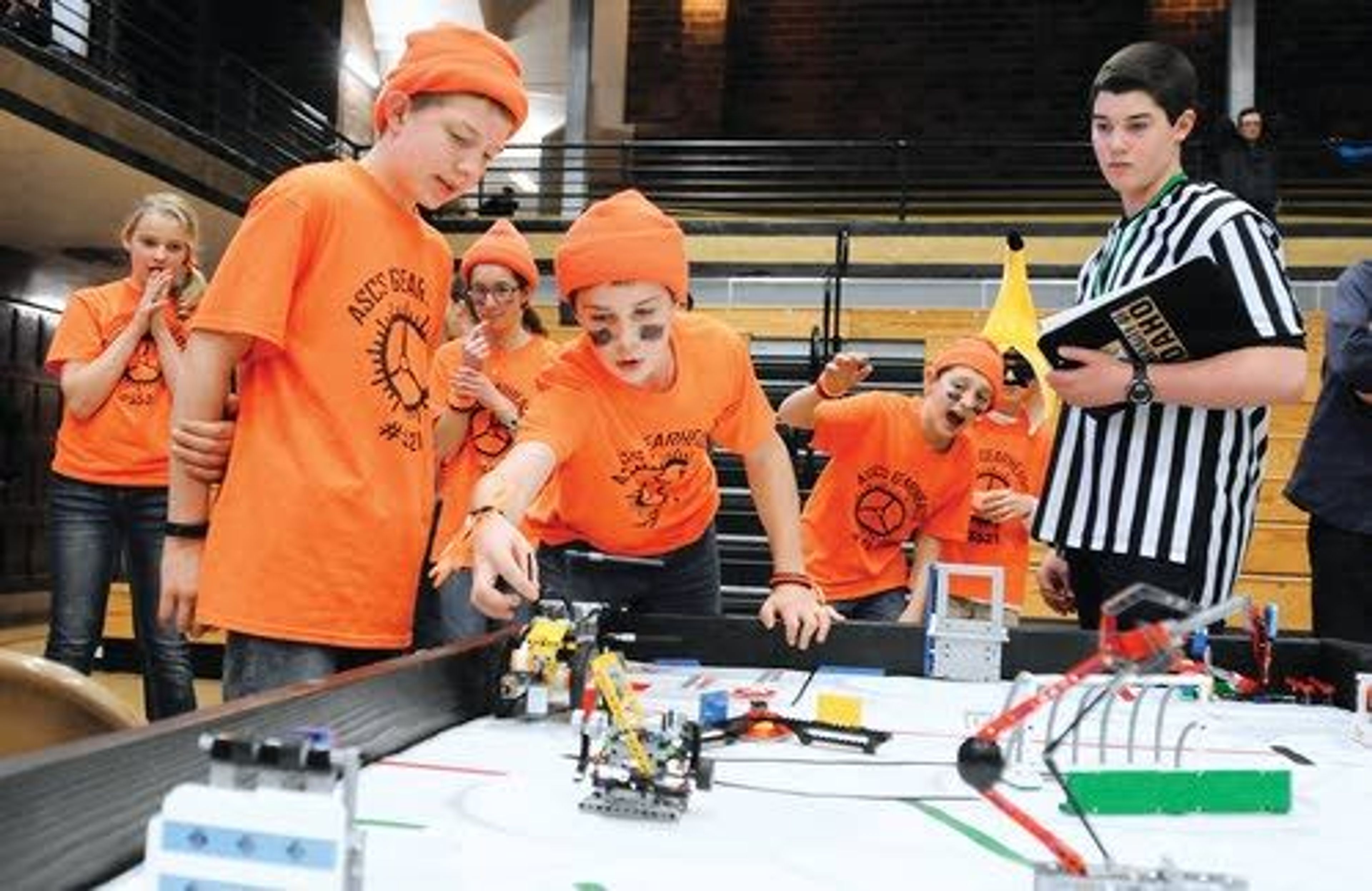 Members of the All Saints Catholic School Gearheads, from Lewiston, gather around the competition table to test their robot during the North Idaho FIRST LEGO League Championship Tournament Saturday at Memorial Gym in Moscow.