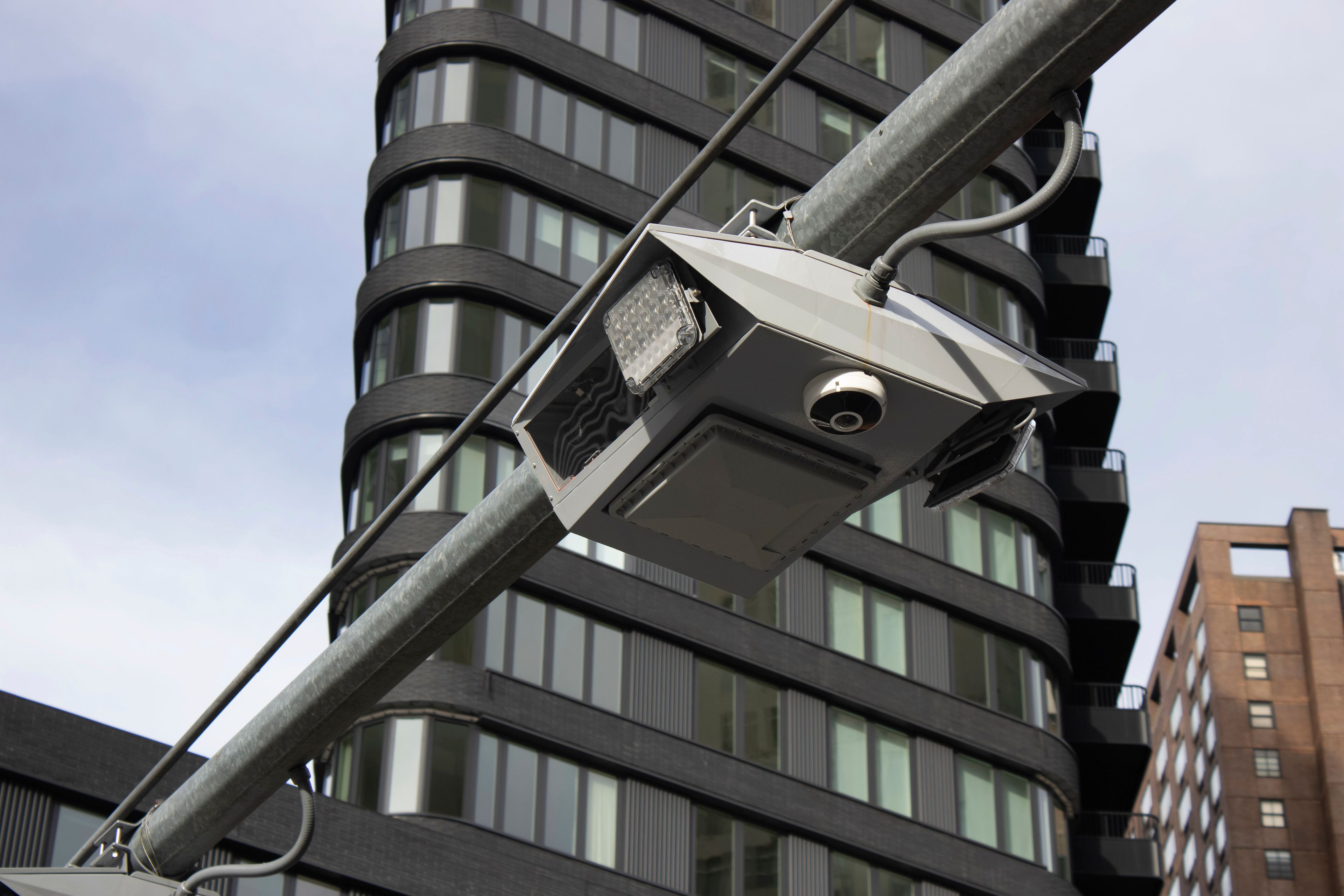 FILE - Recently installed toll traffic cameras hang above West End Ave. near 61st Street in the Manhattan borough of New York, Nov. 16, 2023. The Trucking Association of New York filed a federal lawsuit Thursday, May 30, 2024 against the Metropolitan Transportation Authority, which developed the toll scheme, arguing the fees are unconstitutional because they unfairly target and penalize the trucking industry with higher fees.