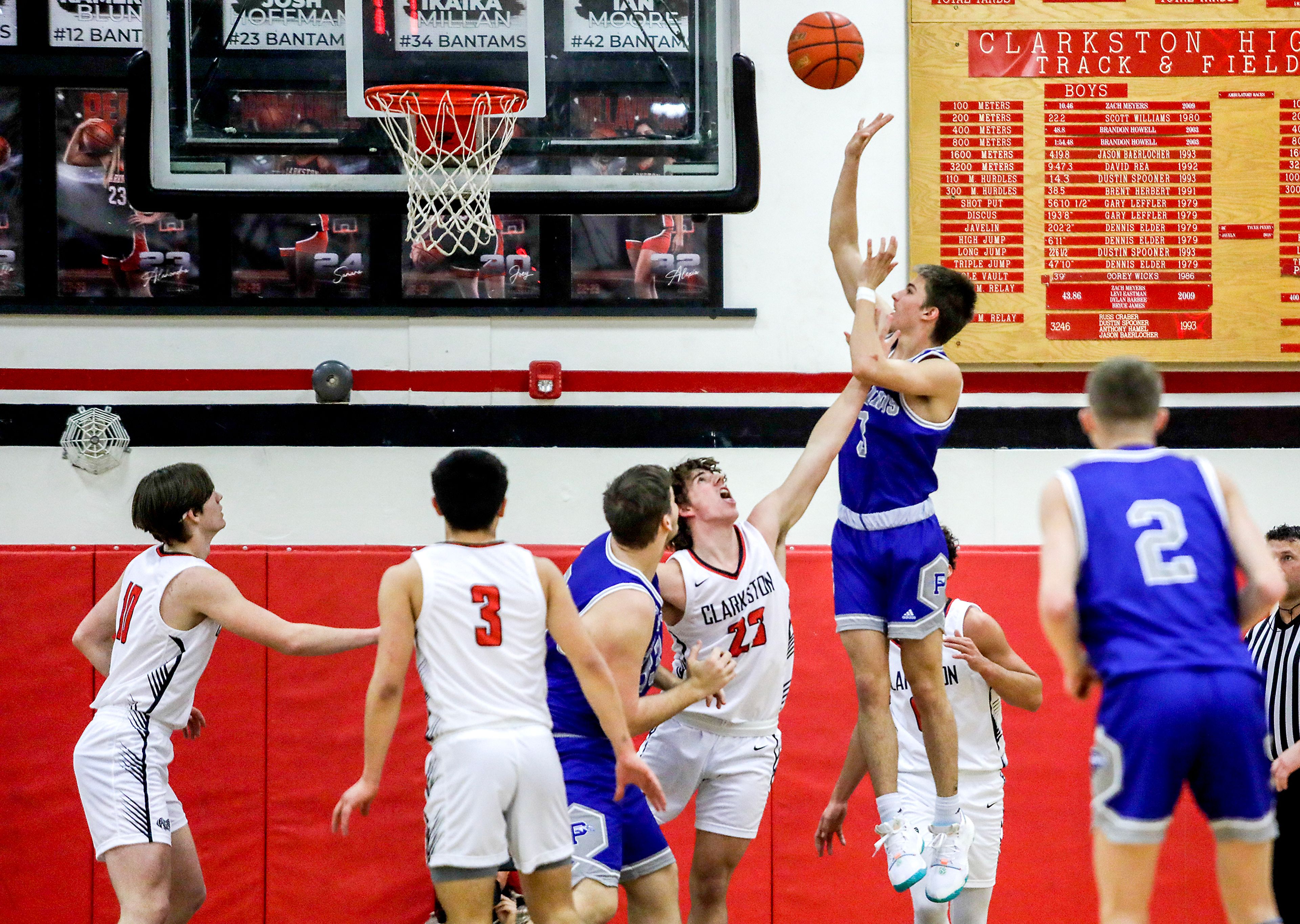 Pullman shooting guard Tanner Barbour, right, shoots as Clarkston forward Josh Hoffman defends during Tuesday's Class 2A Greater Spokane League boys basketball game.