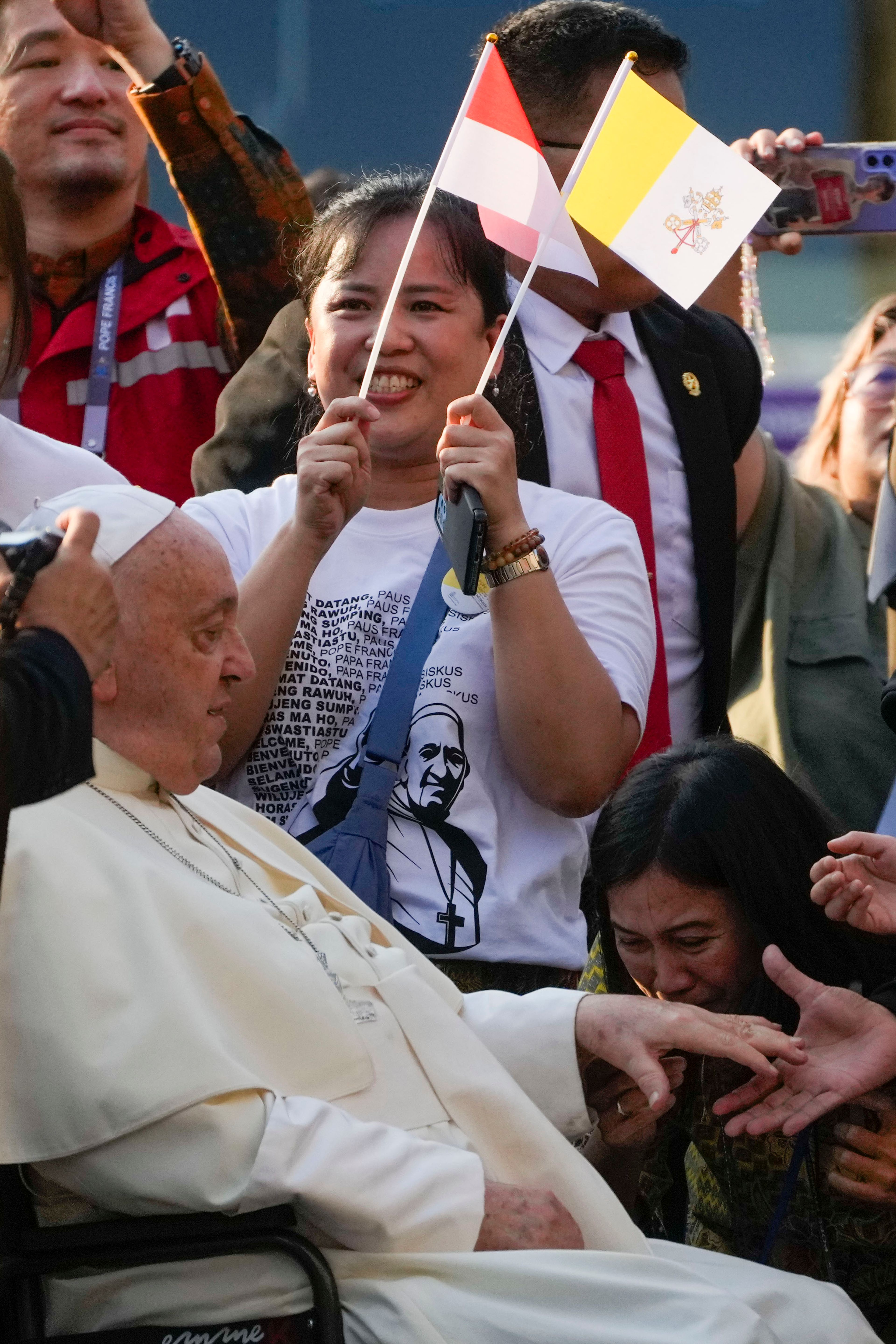 Pope Francis is greeted by faithful as he arrives at the Cathedral of Our Lady of the Assumption in Jakarta, Wednesday, Sept. 4, 2024. Pope Francis urged Indonesia to live up to its promise of "harmony in diversity" and fight religious intolerance on Wednesday, as he set a rigorous pace for an 11-day, four-nation trip through tropical Southeast Asia and Oceania that will test his stamina and health.