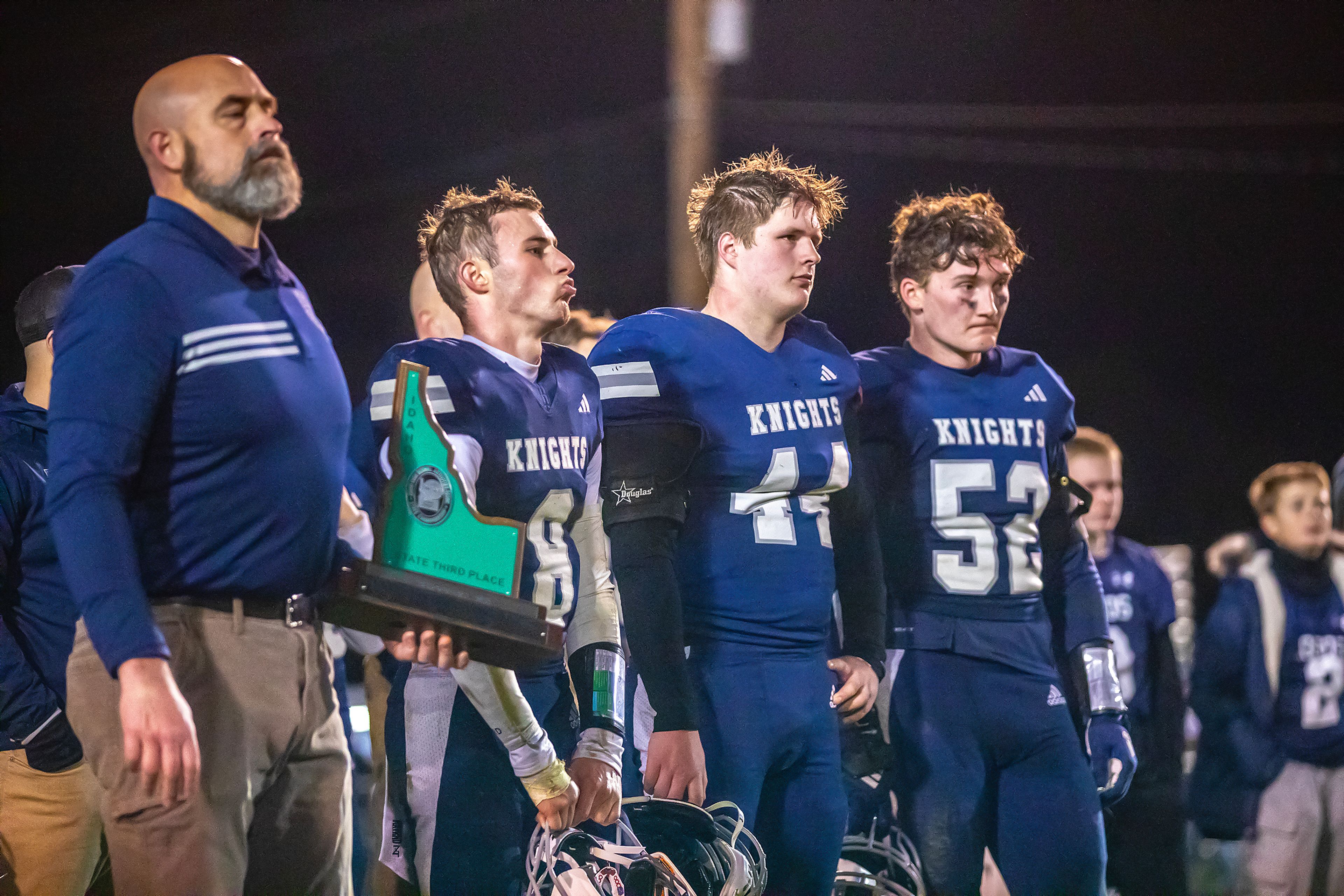 Logos receives the third place trophy following their loss to Kendrick in a semifinal game of the Idaho State Football Class 2A Championships Friday at Bengal Field in Lewiston.