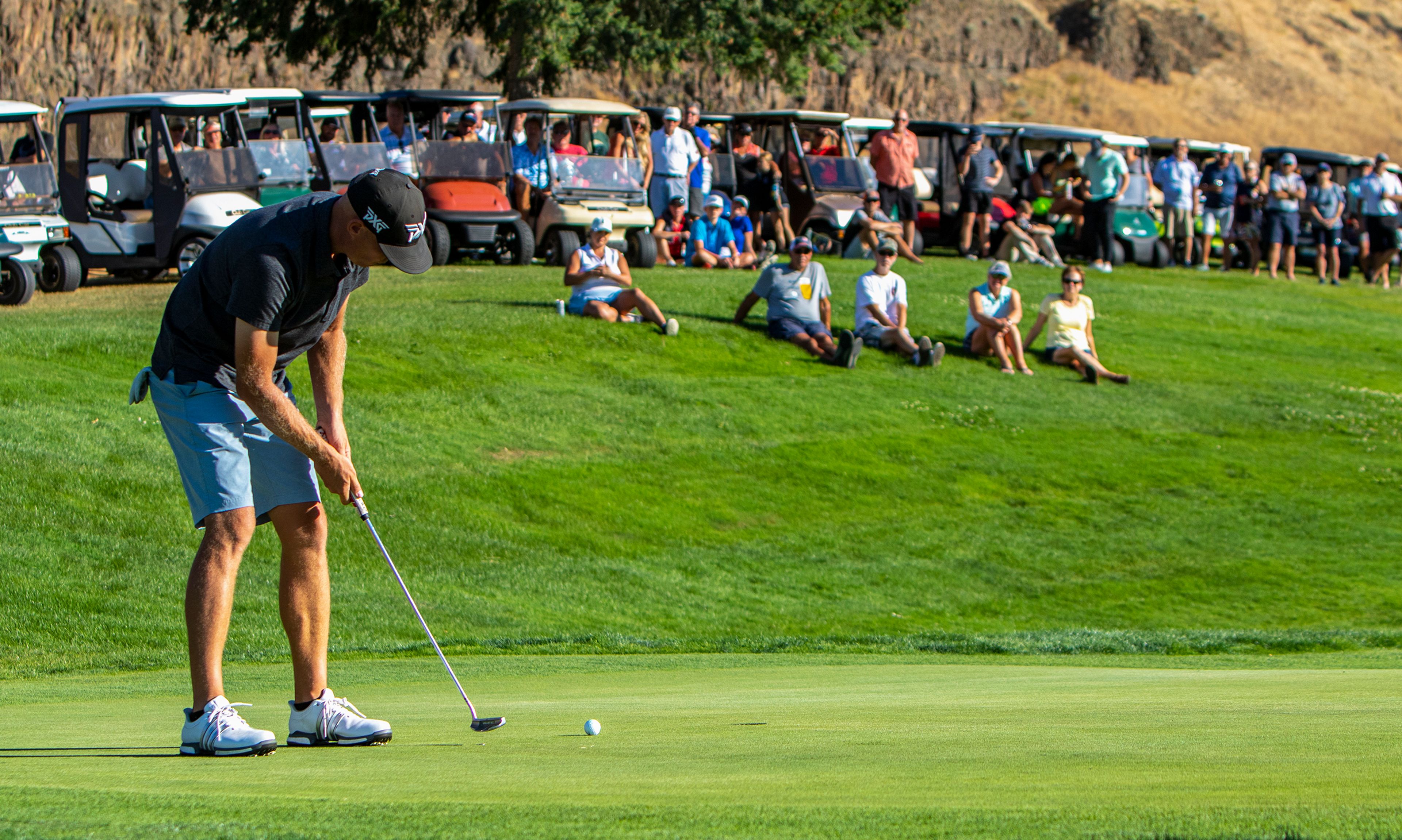 Fans watch as a finalist makes a short putt on the green of the 15th hole during 2022 Sole Survivor golf tournament at the Lewiston Golf and Country Club on Monday.