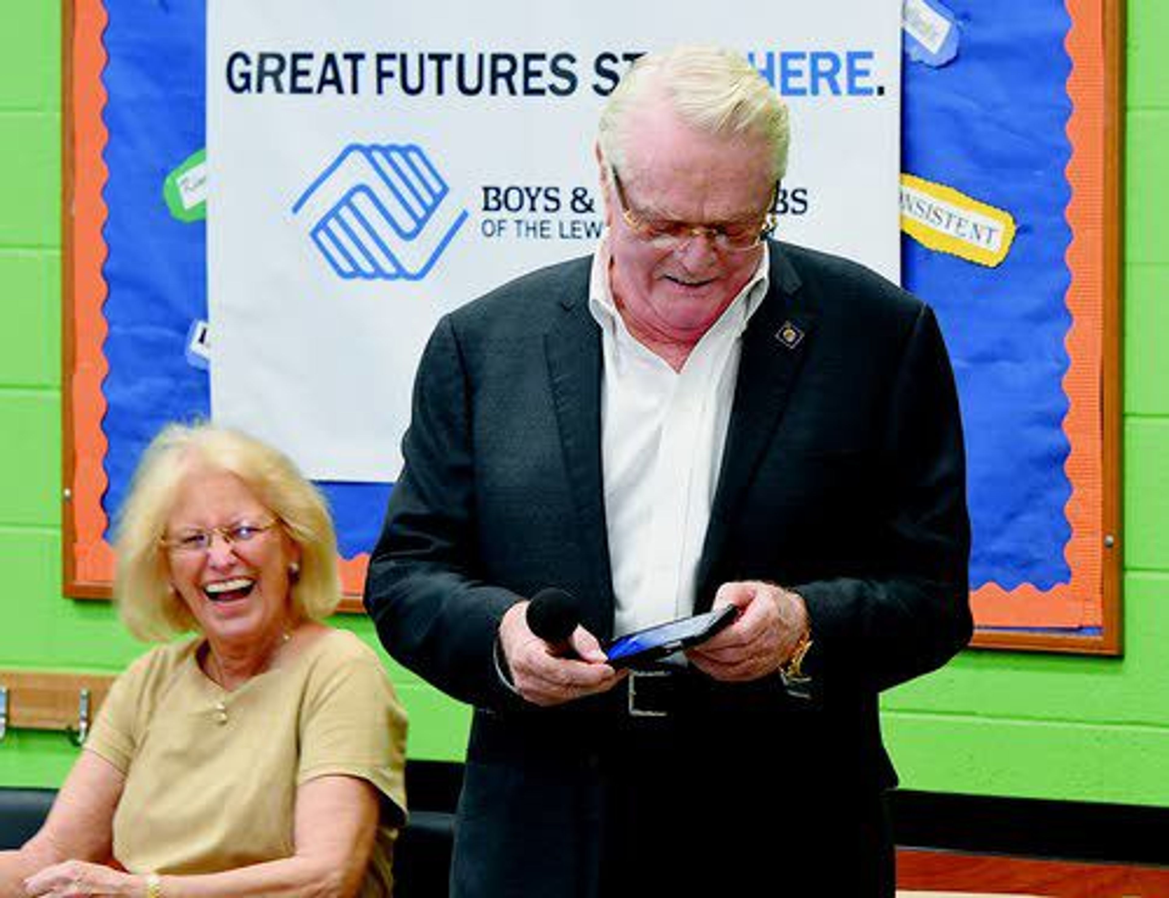 Gary Hughes and his wife, Jutta, get a laugh as Gary mutes his ringing cellphone prior to announcing a $1 million donation to the Boys and Girls Clubs of the Lewis Clark Valley on Thursday at Clarkston.