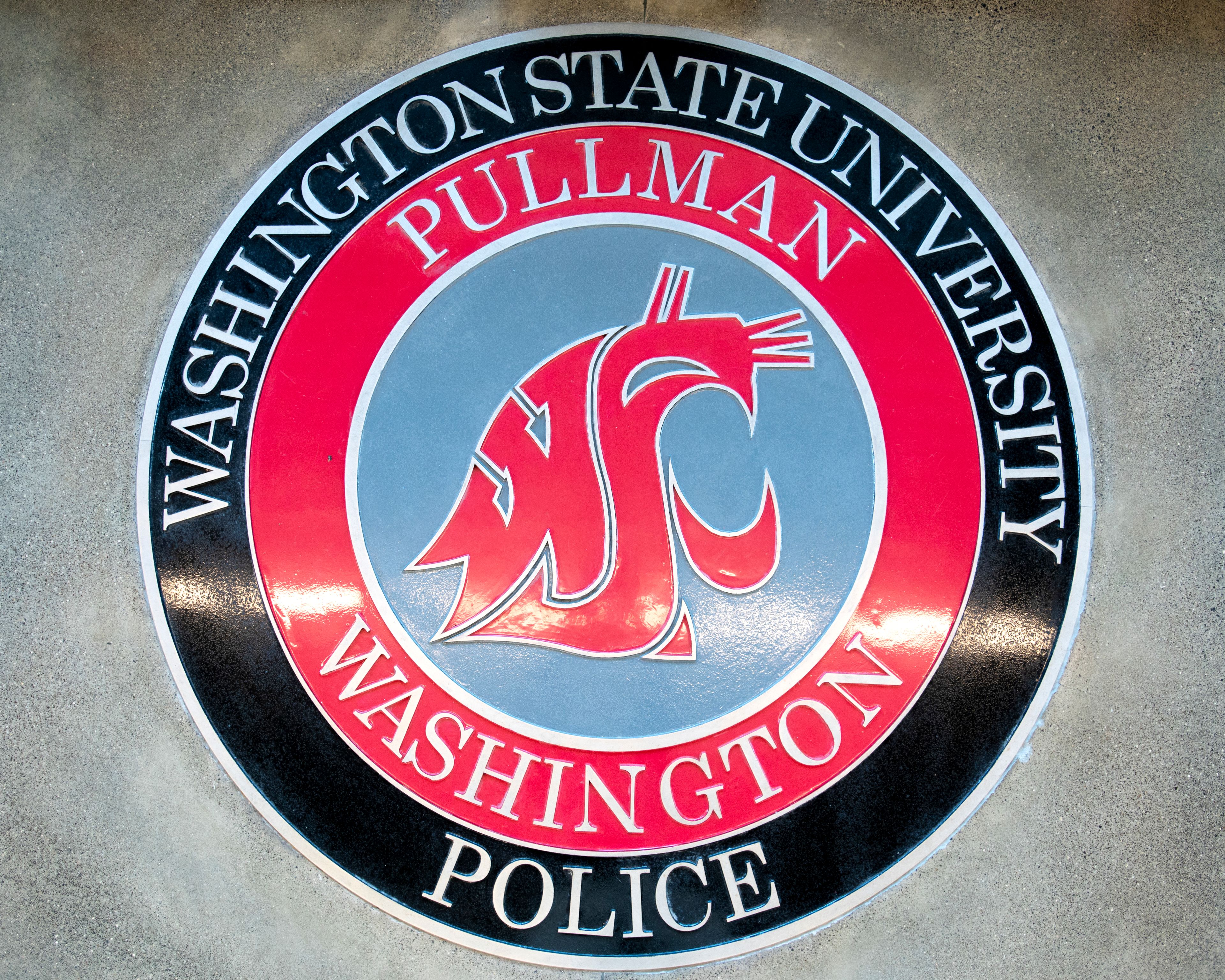 A Washington State University Police logo is photographed in the lobby of WSU’s Police Department in Pullman.